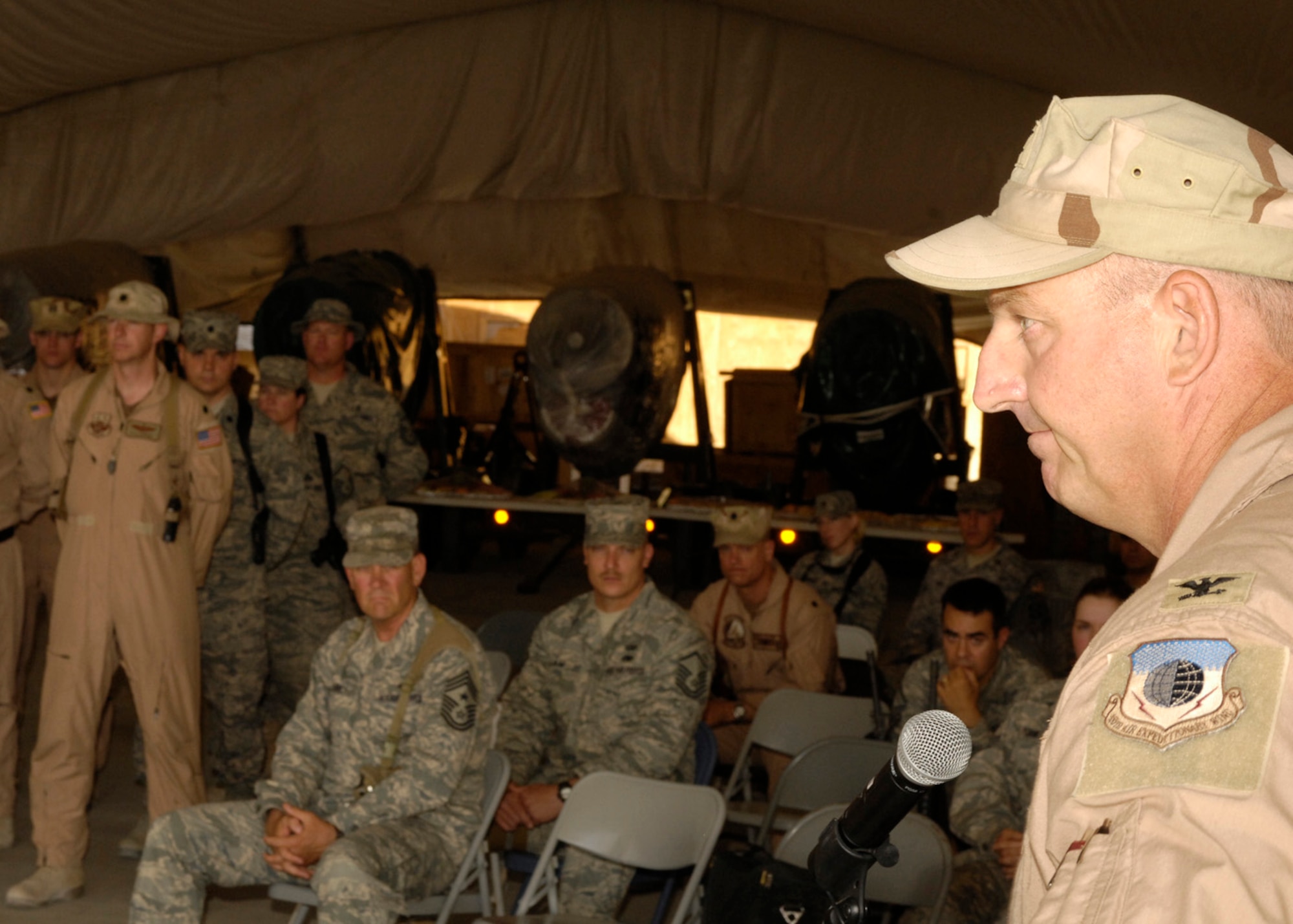 BAGRAM AIR FIELD, Afghanistan -- Col. Tim “Donk” Strasburger (right), 455th Expeditionary Operations Group commander, addresses the audience after accepting command of the group during the ceremony here June 21. (U.S. Air Force photo by Master Sergeant Demetrius Lester)