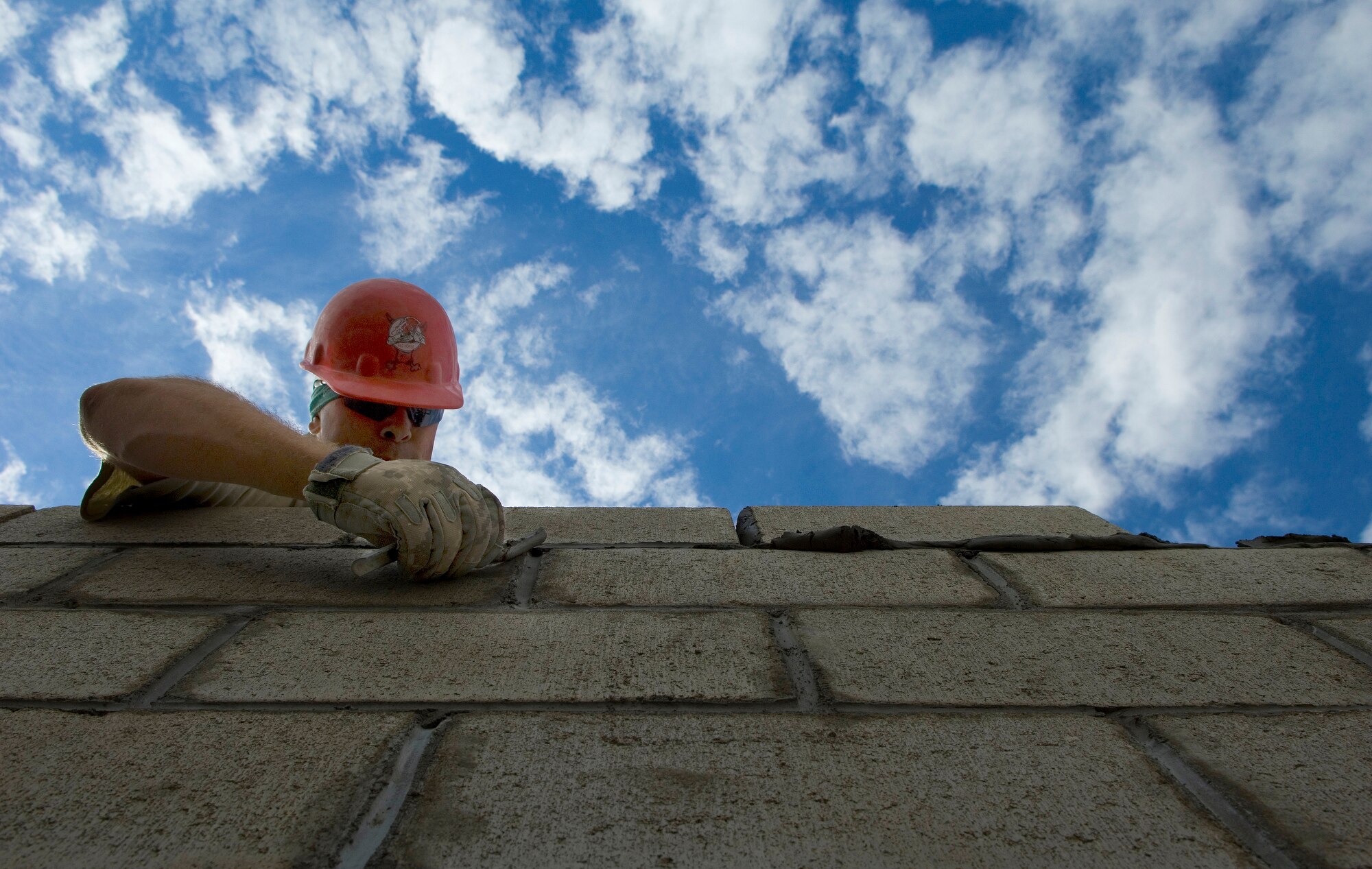 Staff Sgt. Joshua Hallmark clears excess mortar from cinder blocks during the building of a medical clinic in Yanama, Peru, June 23 during New Horizons-Peru 2008, a U.S. and Peruvian partnered humanitarian mission set on providing relief to underprivileged Peruvians. Sergeant Hallmark is a civil engineer with the 820th RED HORSE Squadron at Nellis Air Force Base, Nev. (U.S. Air Force photo/Staff Sgt. Bennie J. Davis III)