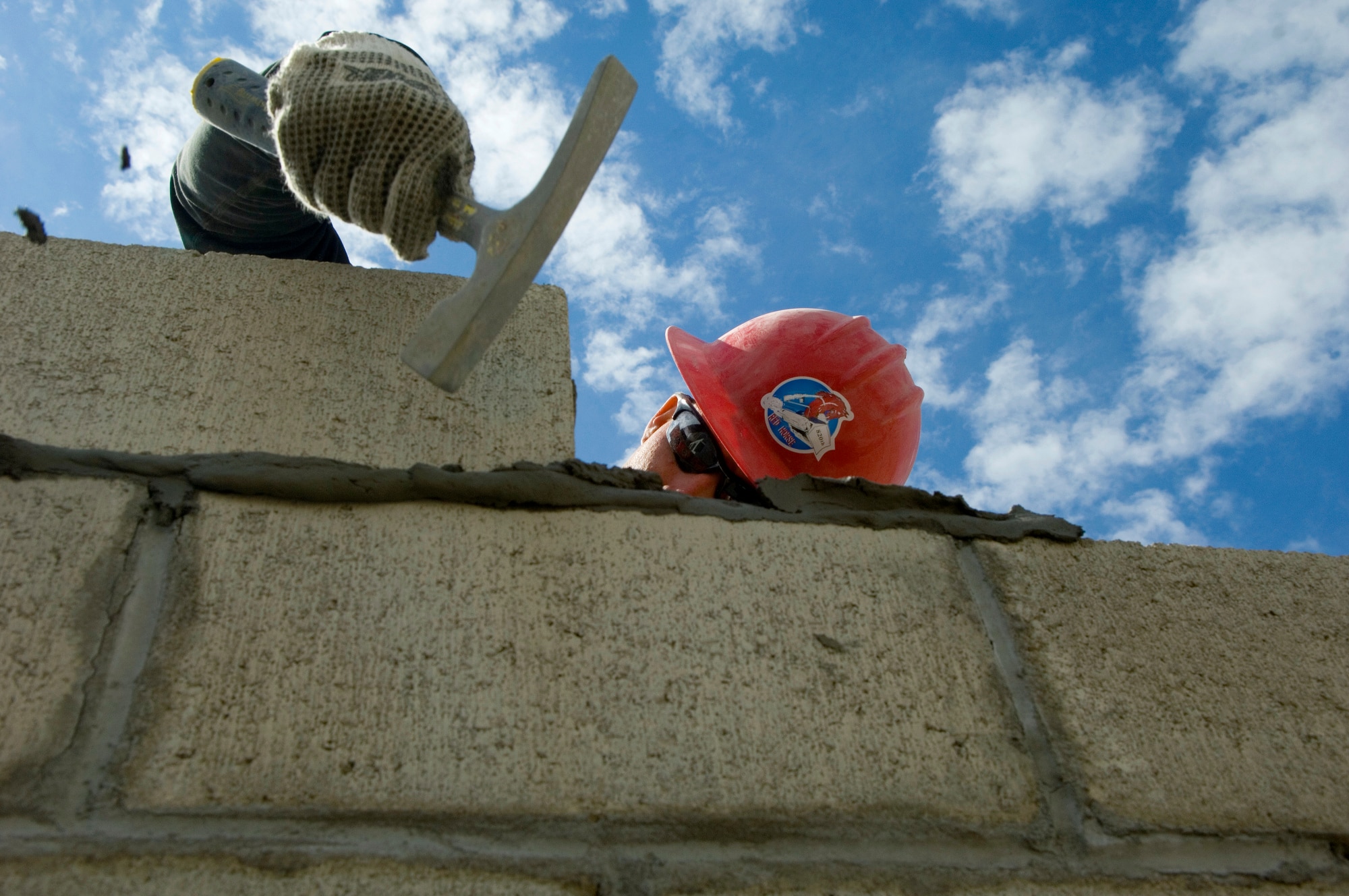 Senior Airman Russell Smith hammers a cinder block into position for the building of a medical clinic in Yanama, Peru, June 23 during New Horizons-Peru 2008, a U.S. and Peruvian partnered humanitarian mission set on providing relief to underprivileged Peruvians. Airman Smith is a member of the 820th RED HORSE Squadron at  Nellis Air Force Base, Nev. (U.S. Air Force photo/Staff Sgt. Bennie J. Davis III)