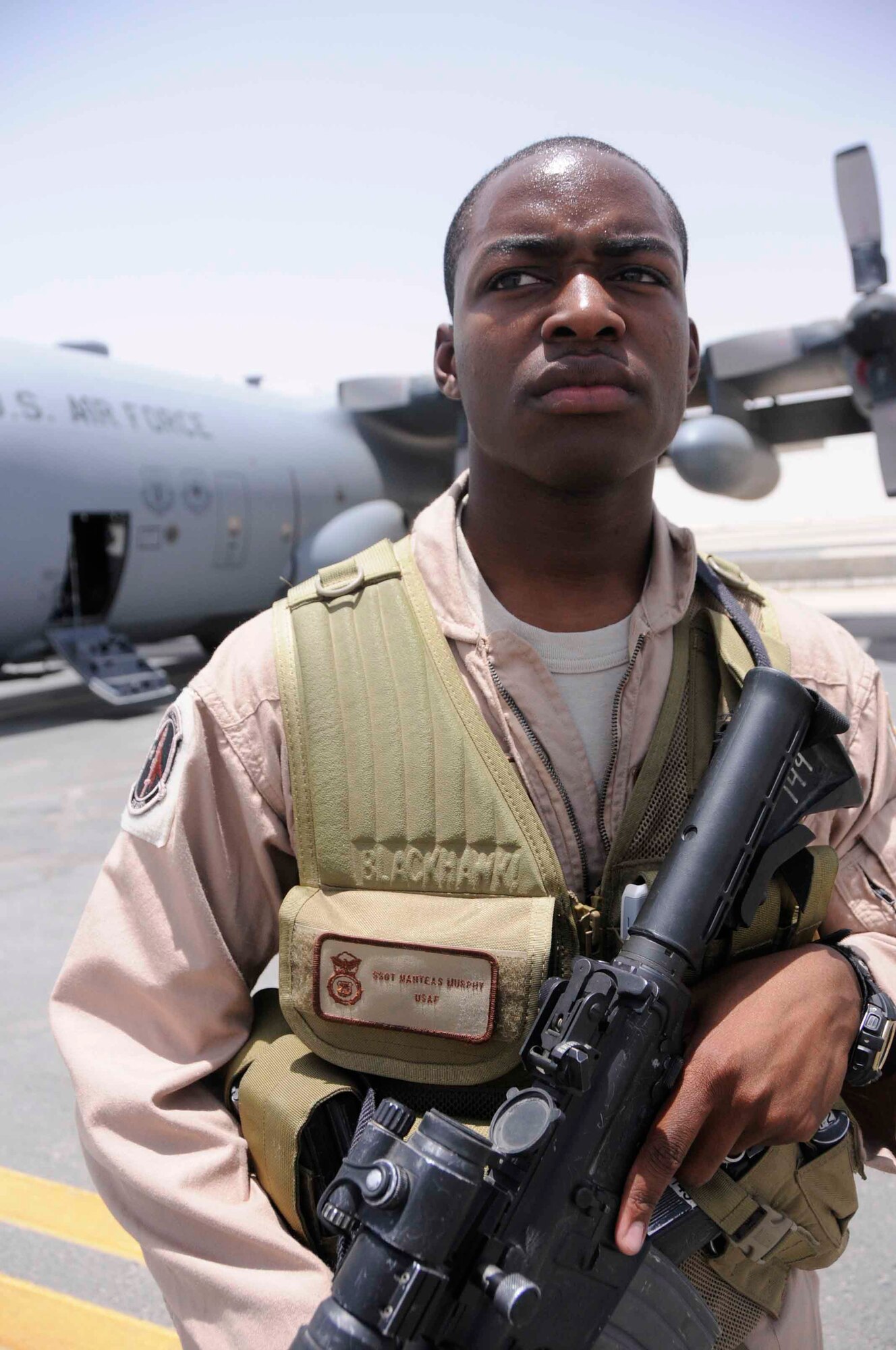 SOUTHWEST ASIA—Staff Sgt Nahteas Murphy, 379th Expeditionary Security Forces Squadron Fly Away Security Team, guards the perimeter of a C-130 aircraft June 24. The primary mission of the FAST is to protect U.S. Air Force and U.S. military assets and resources from harm while they're in areas not occupied by any other security agents. (U.S. Air Force photo/ Senior Airman Domonique Simmons)