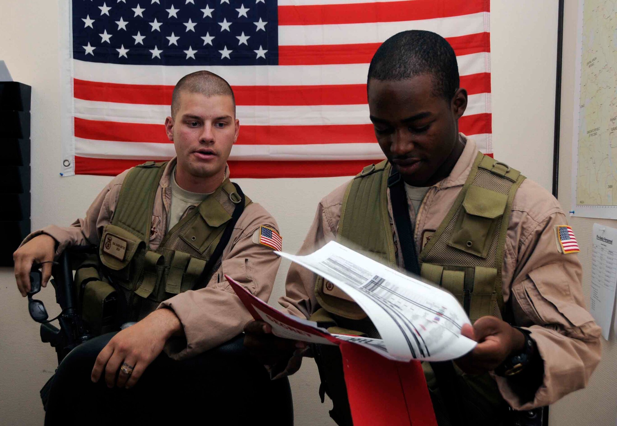 SOUTHWEST ASIA—Staff Sgt. Nahteas Murphy reviews a mission schedule with Senior Airman David Mattox June 24. Members of the Fly Away Security Team have to be ready to combat many challenges including varying work hours, fatigue, and relocating constantly. (U.S. Air Force photo/ Senior Airman Domonique Simmons)