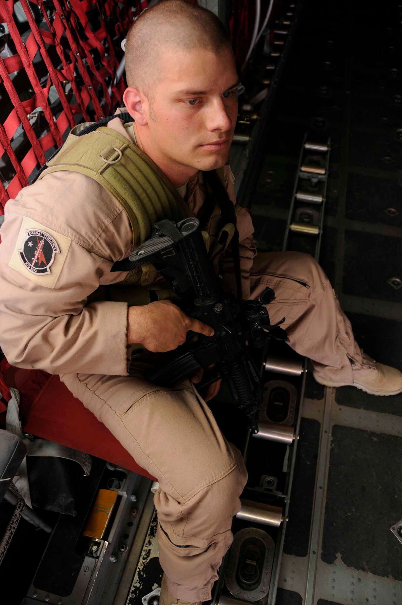 SOUTHWEST ASIA—Senior Airman David Mattox, 379th Expeditionary Security Forces Squadron Fly Away Security Team, is ready to begin his task of securing the C-130 aircraft he is seated in June 24. He is deployed from Andrews Air Force Base, Md. (U.S. Air Force photo/ Senior Airman Domonique Simmons)