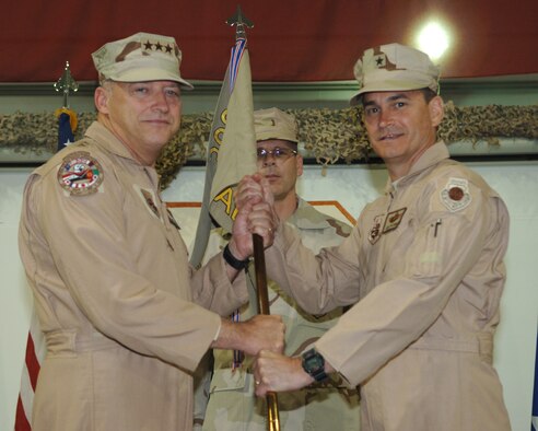 Brig. Gen. H.D. Polumbo, Jr., 380th Air Expeditionary Wing commander, receives the wing guidon from Lt. Gen. Gary North, Ninth Air Force and U.S. Air Forces Central commander, during the wing change of command ceremony, June 16.(U.S. Air Force photo/Airman 1st Class Kelly LeGuillon)