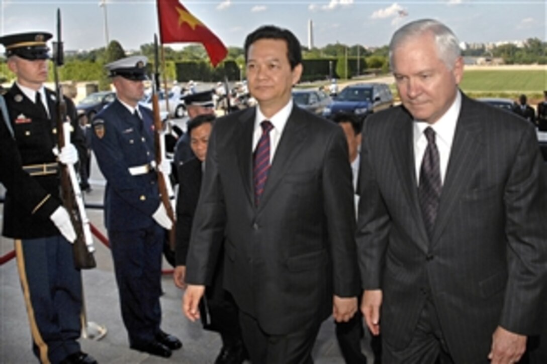 Defense Secretary Robert M. Gates, right, escorts Vietnamese Prime Minister Nguyen Tan Dung through a cordon of honor guards and into the Pentagon on June 24, 2008.  The leaders discussed a range of regional security issues of mutual interest to both nations.  