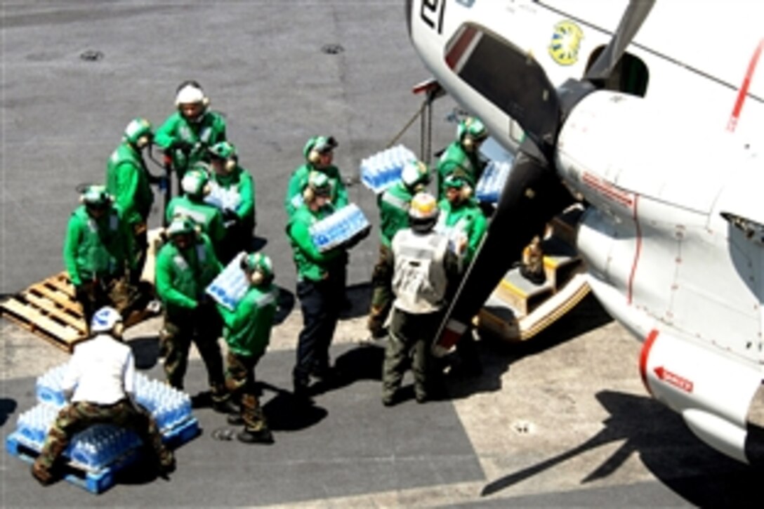 U.S. Navy sailors load cases of water bound for the Philippines onto a C-2A Greyhound assigned to Fleet Logistics Combat Support Squadron 30 on the flight deck of the Nimitz-class aircraft carrier USS Ronald Reagan, June 25, 2008. The USS Ronald Reagan sent 12,000 bottles of water and 7,500 pounds of rice to the Philippines for humanitarian relief to the victims of Typhoon Fengshen. 