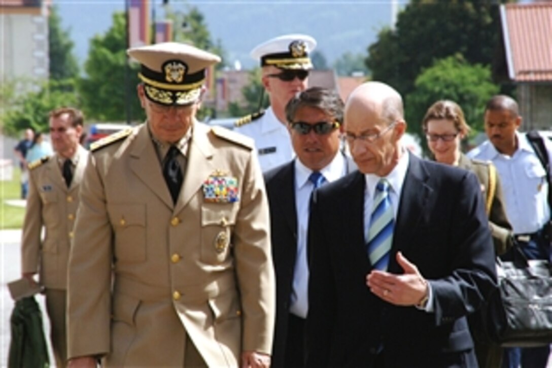 U.S. Navy Adm. Mike Mullen, chairman of the Joint Chiefs of Staff, left, and Dr. John P. Rose, director of the George C. Marshall European Center for Security Studies, on their way from the center’s helipad to the plenary hall, Garmisch-Partenkirchen, Germany, June 25, 2008. 