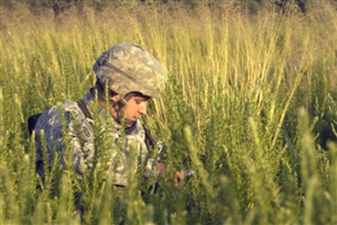 U.S. Army Sgt. Able Gomez prepares to move to a rally point after participating in a joint airdrop at Fort Bragg, N.C., June 18, 2008. Gomez is assigned to the 82nd Airborne Division's 505th Parachute Infantry Regiment. 
