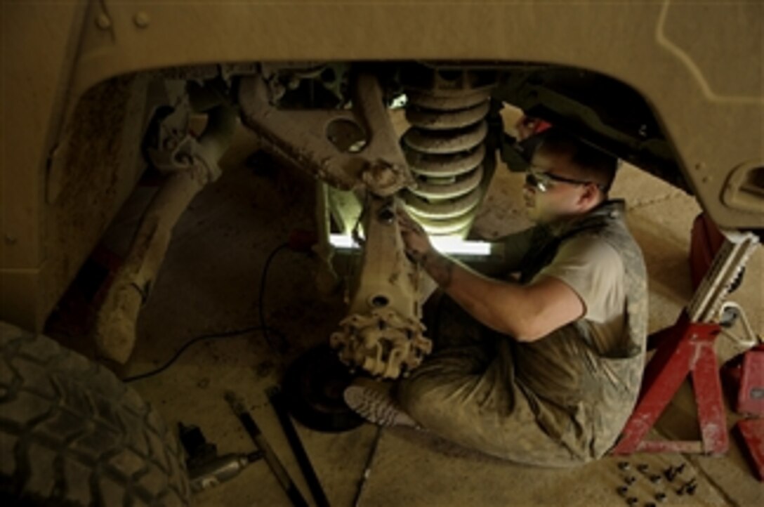 U.S. Air Force Staff Sgt. Charles Pierce replaces a differential on a high mobility wheeled vehicle at Sather Air Base, Iraq, on May 12, 2008.  Pierce is deployed from Cannon Air Force Base, N.M.  