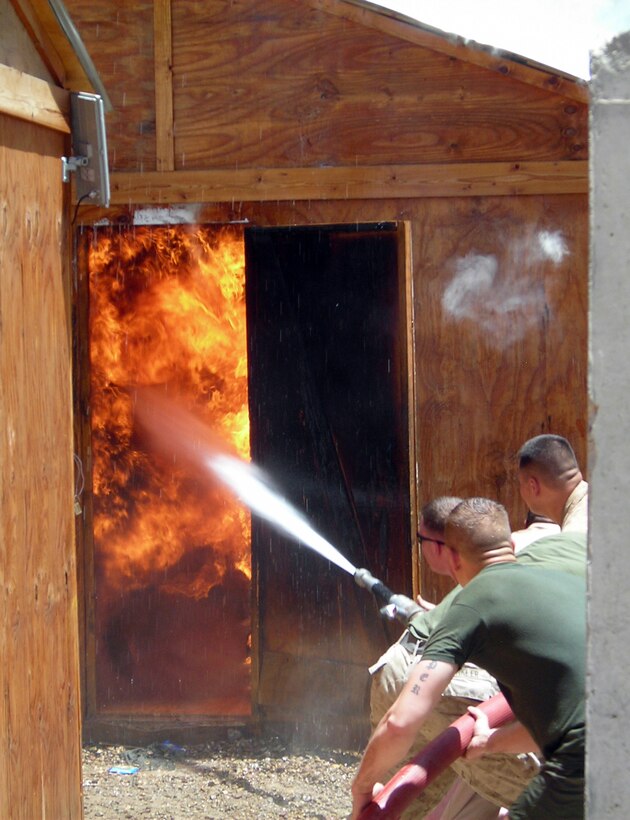 FALLUJAH, Iraq (June 25, 2008) – Marines with Company L, 3rd Battalion, 6th Marines fight the fire that destroyed structures at Entry Control Point-5 (ECP-5), June 25. The fire spread throughout the post and burned down every wooden hut, leaving most of the Marines without equipment or personal possessions. The company said it has received generous support from local Iraqis, neighboring units and stateside supporters to recover from the incident. (Official U.S. Marine Corps photo by Company L, 3rd Battalion, 6th Marines) (RELEASED)