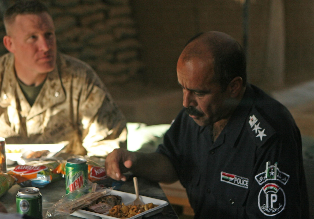 (left) Lt. Col. Brett A. Bourne, the commanding officer of 1st Battalion, 9th Marine Regiment, Regimental Combat Team 1, and Col. Saleh Mahdi Shaheen al-Alwani, the district chief of police for Ramadi, enjoys a meal cooked by the 1st Battalion, 9th Marines’ food service specialist at the battalion’s command operating center on Camp Ramadi June 25. “It’s great to host the Iraqis,” said Staff Sgt. Van Jenkins, a food service specialist with 1st Battalion, 9th Marines, and a certified chef. “It shows a great gesture of friendship. Food is one of those special things that brings people together and allows everybody to just sit down and talk about anything.” (Official U.S. Marine Corps photo by Lance Cpl. Casey Jones)