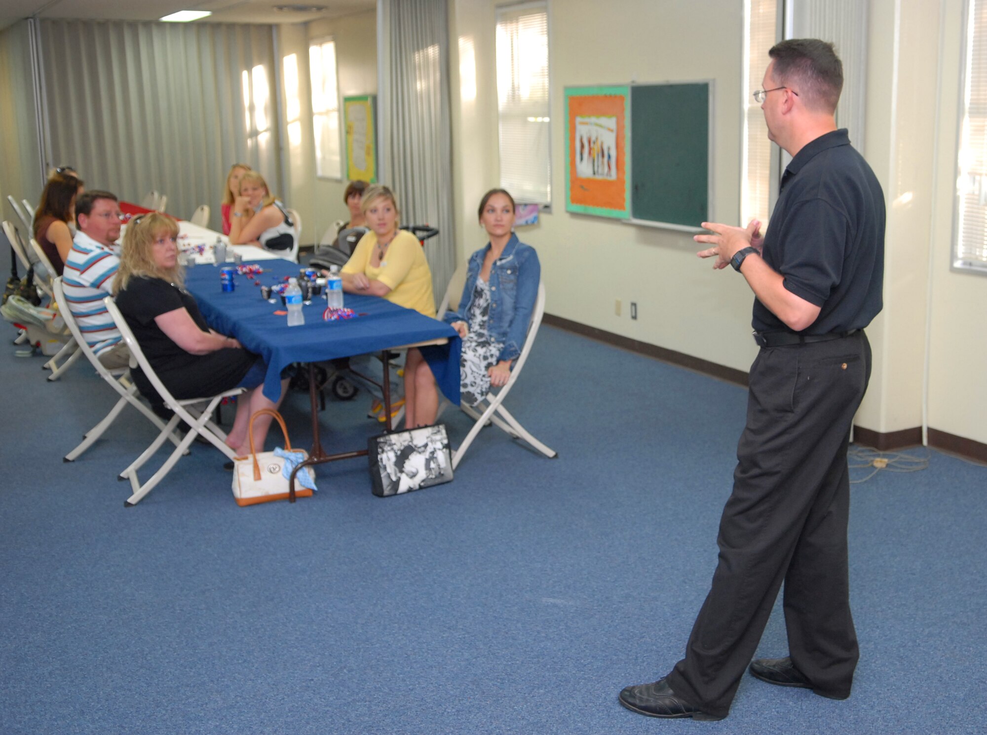 Chaplain Eric Whitmore, 18th Wing Chapel speaks to spouses of military members who are assigned to a deployed location during the monthly Deployed Spouses Dinner Jun 21.  The monthly event is coordinated and hosted by numerous base agencies and organizations to provide deployed spouses a few hours of fun and relaxation.  (U.S. Air Force photo/Staff Sgt. Christopher Marasky)