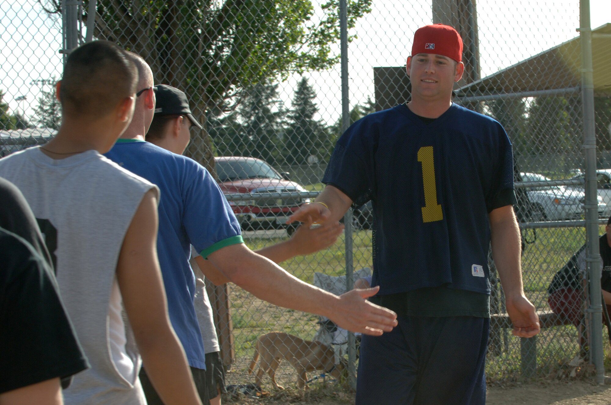 FAIRCHILD AIR FORCE BASE, Wash. – Staff Sgt. Douglas Middendorf, 92nd Operation Support Squadron combat crew communications operator, is welcomed at home plate by the 92nd OSS softball team after hitting one out of the park here June 25. (U.S. Air Force photo / Senior Airman Jocelyn Ford)
