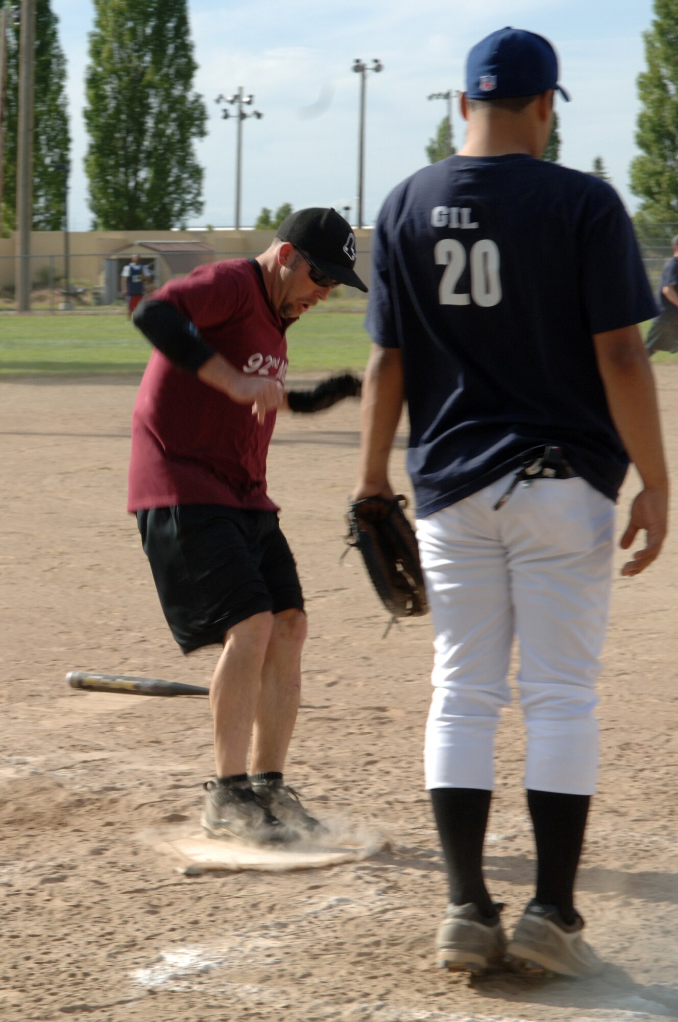 FAIRCHILD AIR FORCE BASE, Wash. – Justin Crump jumps on home plate, scoring another run for the 92nd Medical Group softball team during a meet against the 92nd Services Squadron here June 25. (U.S. Air Force photo / Senior Airman Jocelyn Ford)