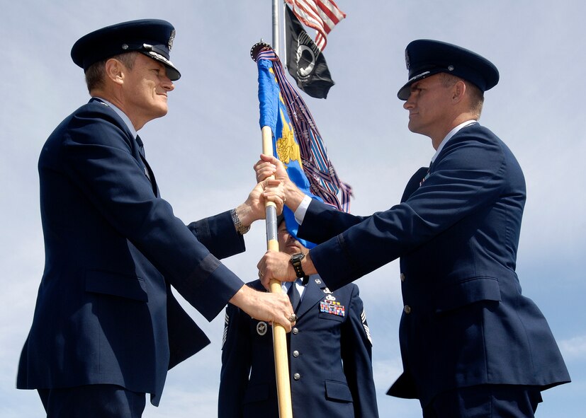 FAIRCHILD AIR FORCE BASE, Wash. – Maj. Gen. Irving Halter, 19th Air Force commander, presents Col. Scott Greene, 336th Training Group commander, with the group guideon during the 336th TRG change-of-command ceremony here June 26. Colonel Greene has held operational assignments in four major commands and in four different countries, with experience in the Pacific, European, and Central Command areas of operation.  (U.S. Air Force photo / Senior Airman Eunique Stevens)
