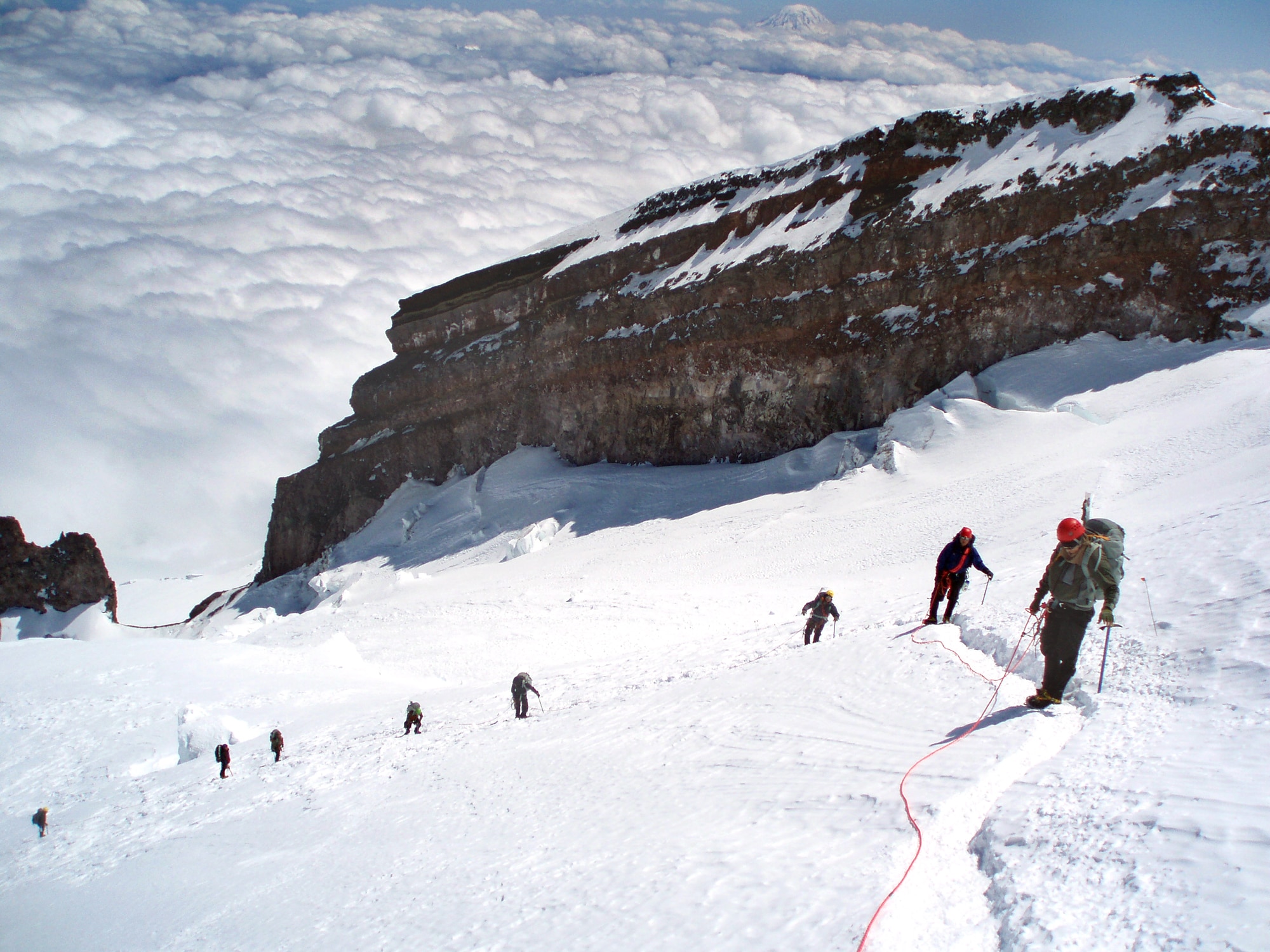 PIERCE COUNTY, Wash. – Sixteen 22nd Training Squadron Delta Flight Survival, Evasion, Resistance and Escape specialists climb Mount Rainier to experience firsthand the difficulties of navigating steep and hazardous terrain June 17. The use of crampons, ice axes and climbing harnesses rigged to each other on four man rope teams ensured the safe summit of Mount Rainier. (Courtesy photo / Delta Flight)