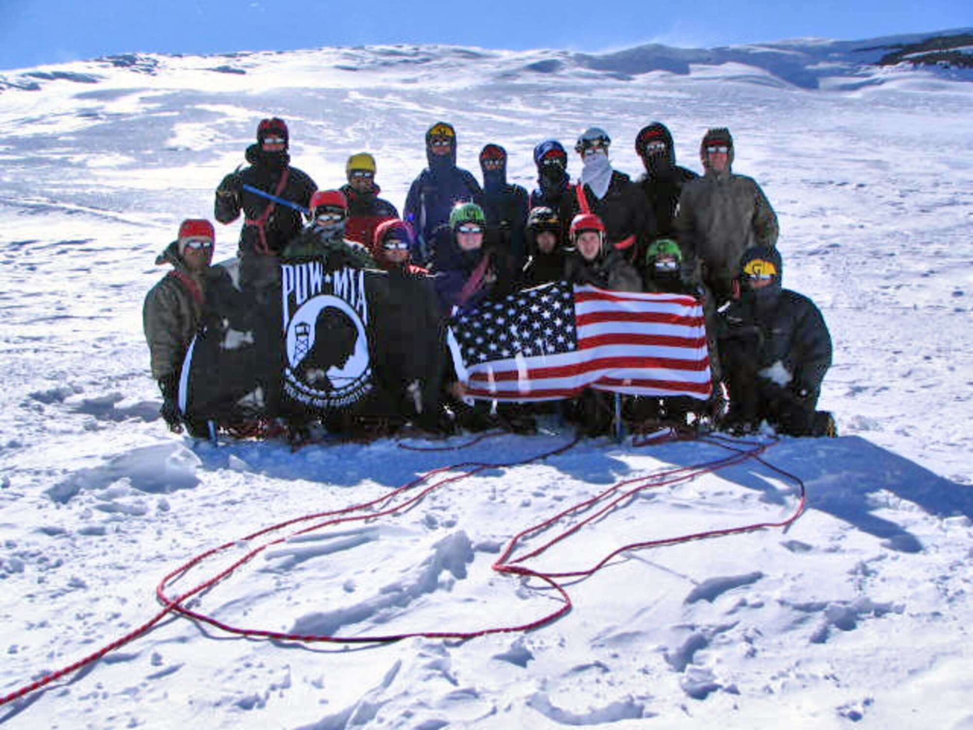 PIERCE COUNTY, Wash. – Sixteen 22nd Training Squadron Delta Flight Survival, Evasion, Resistance and Escape specialists pose for a photo at the summit of Mount Rainier, elevation 14,410 feet, June 17. The 16 instructors summited the mountain in 10 hours. (Courtesy photo / Delta Flight)