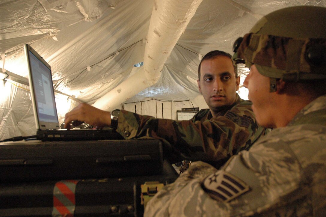 MCGUIRE AIR FORCE BASE, N.J. -- Staff Sgt. Kasim Mothana a Reserve communication specialist configures the secure iinternet in the early stages of an Eagle Flag exercise held at Lakehurst Naval Air Station, Lakehurst, N.J. Eagle Flag gives participants an opportunity to practice opening an airbase under bare base conditions. (U.S. Air Force photo/Master Sgt. Donna T. Jeffries)