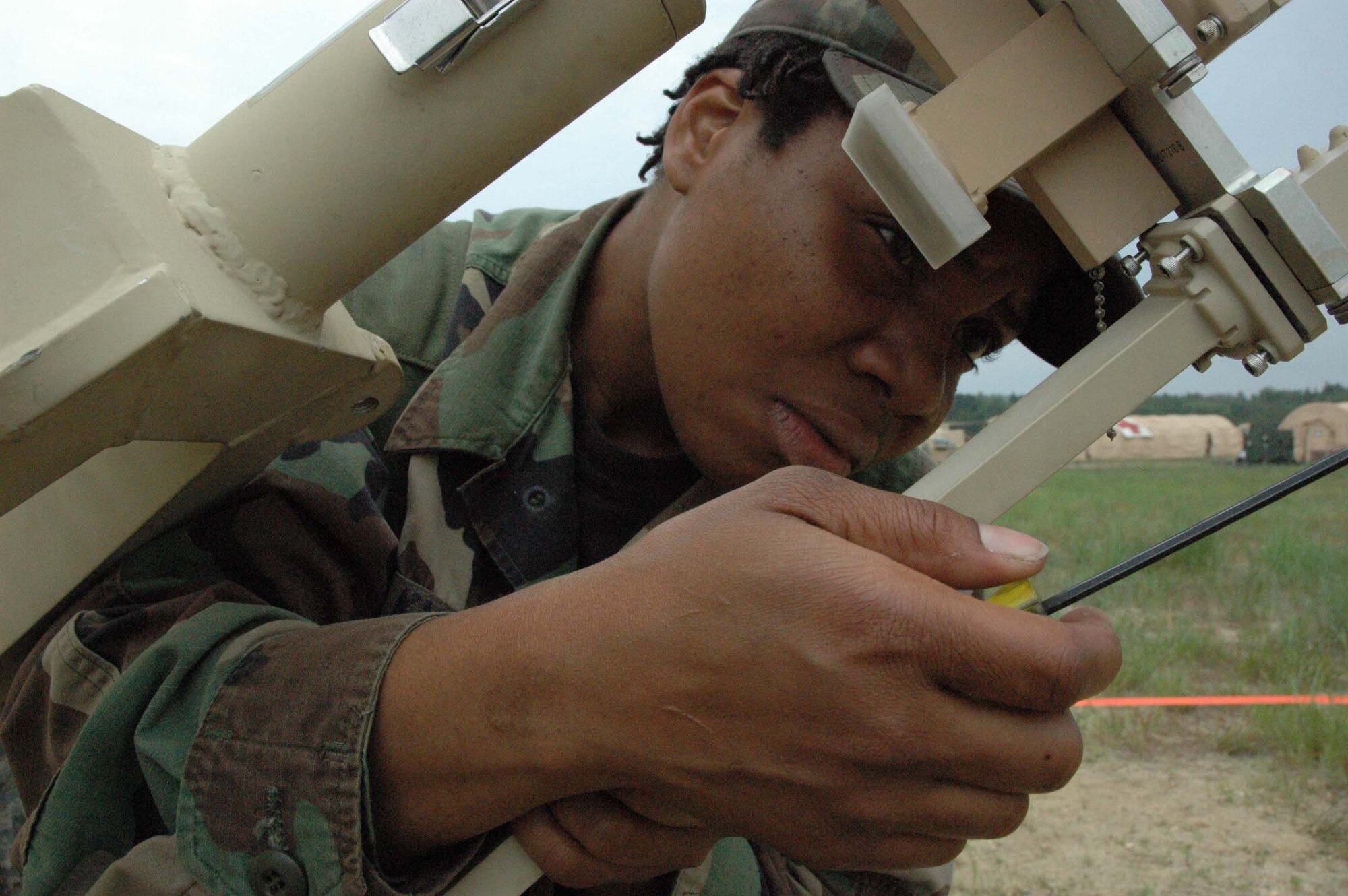 MCGUIRE AIR FORCE BASE, NJ -- Senior Airman Keisha Kydd a Reserve satellite communication specialist, disassemblies a satellite dish in preparation for impending high winds during a recent Eagle Flag exercise held at Lakehurst Naval Air Station, Lakehurst, N.J. Eagle Flag gives participants an opportunity to practice opening an airbase under bare base conditions. (U.S. Air Force photo/Master Sgt. Donna T. Jeffries)