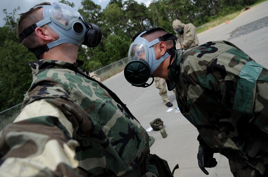 MOODY AIR FORCE BASE, Ga. -- Airman Daniel Camacho, 23rd Equipment Maintenance Squadron A-10C Thunderbolt II crash recovery technician, performs a buddy check on Tech. Sgt. Sam McGivern, 23rd EMS NCO-in-charge of HH-60G Pave Hawk phase dock, during chemical warfare training here June 23. The training must be refreshed periodically to ensure Airmen are prepared to deploy. (U.S. Air Force photo by Senior Airman Gina Chiaverotti) 
