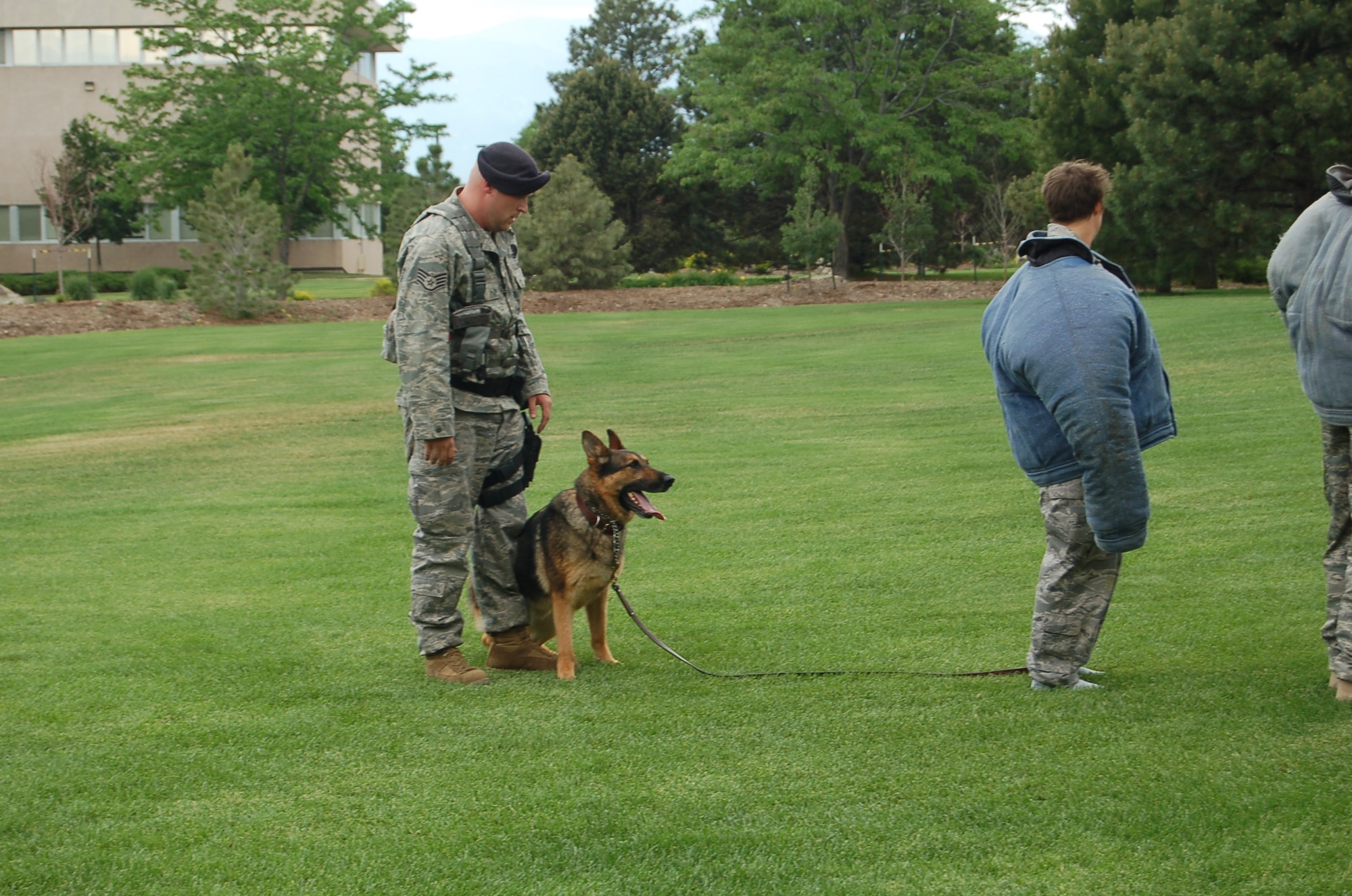 Staff Sgt. Billy Burgan, 21st Security Forces Squadron military working dog handler, is briefing two simulated  suspects that if they make any aggressive actions towards him, his dog, Endy, will bite without command before approaching them to search.  The exercise was a part of the section’s first internal “Top Dog” competition to get military Working Dog handlers and dogs ready for several competitions in the future. (Air Force Photo/Chief Master Sgt. Michael Zirkle)