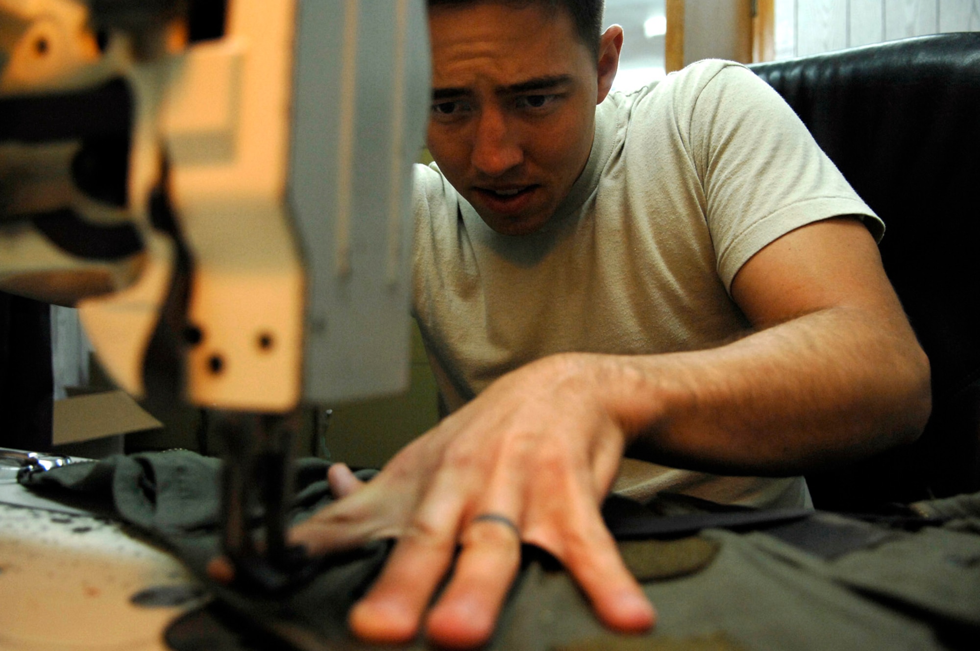 Senior Airman Nicholas Sanders sews a tear in an anti-G suit June 23 at Joint Base Balad, Iraq. The suit is worn by F-16 Fighting Falcon pilots to combat the gravitational forces experienced during high-speed maneuvers. The suit prevents blood from rushing out of the brain, helping the pilot to maintain consciousness during flight. The technicians are responsible for the maintenance and operability of all the F-16 pilot gear, including their helmets and survival equipment. Airman Sanders is a 77th Expeditionary Fighter Squadron aircraft equipment technician deployed from Shaw Air Force Base, S.C. (U.S. Air Force photo/Senior Airman Julianne Showalter) 