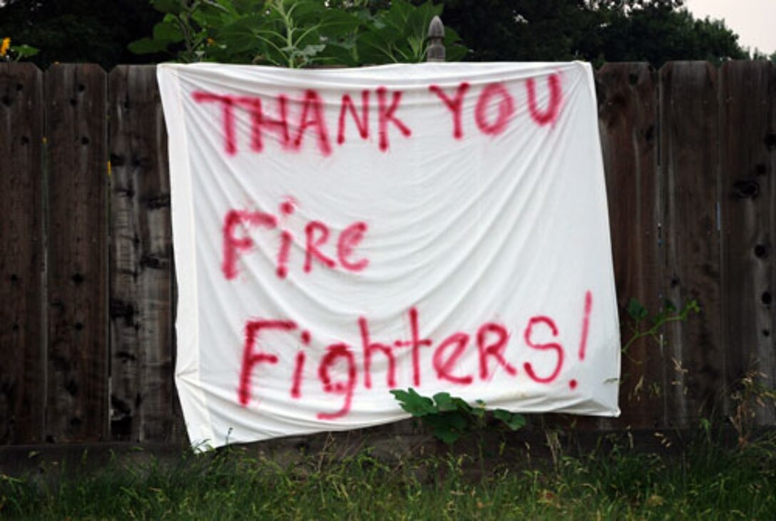A resident of Chico, Calif., proudly displays a message of thanks for local firefighters June 25. Residents in the city of more than 84,000 are seeing more firefighters and military members as additional manpower is needed to fight the state’s raging wildfire. Military members here are using the C-130 Hercules tactical airlift aircraft, which uses the modular airborne firefighting system, or ‘MAFFS,’ to drop up to 30,000 pounds of water or fire retardant on or in front of fire lines. The Airmen in Chico are assigned to the 302nd Air Expeditionary Group at the Chico airport. The group is made up of three Air National Guard units, including the 153rd AW, from Cheyenne, Wyo.; the 146th AW, from Channel Islands, Calif.; and the 145th AW, Charlotte, N.C. One Air Force Reserve unit, the 302nd AW from Peterson Air Force Base, Colo., is the only Air Force Reserve unit in the 302nd AEG. (U.S. Air Force photo/Senior Airman Stephen Collier)
