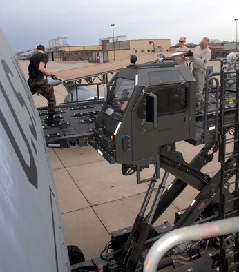 (Left to Right) Airman Christopher Graybill, Senior Airman eric Grotegut and Tech. sgt. Thomas Lillevold, 27th Aerial Port Squadron, load school supplies donated by area citizens aboard a KC-10. The supplies will be delivered to schools in Honduras, South America, as part of the Department of Defense Denton Program. Air Force Photo/Master Sgt. Paul Zadach.