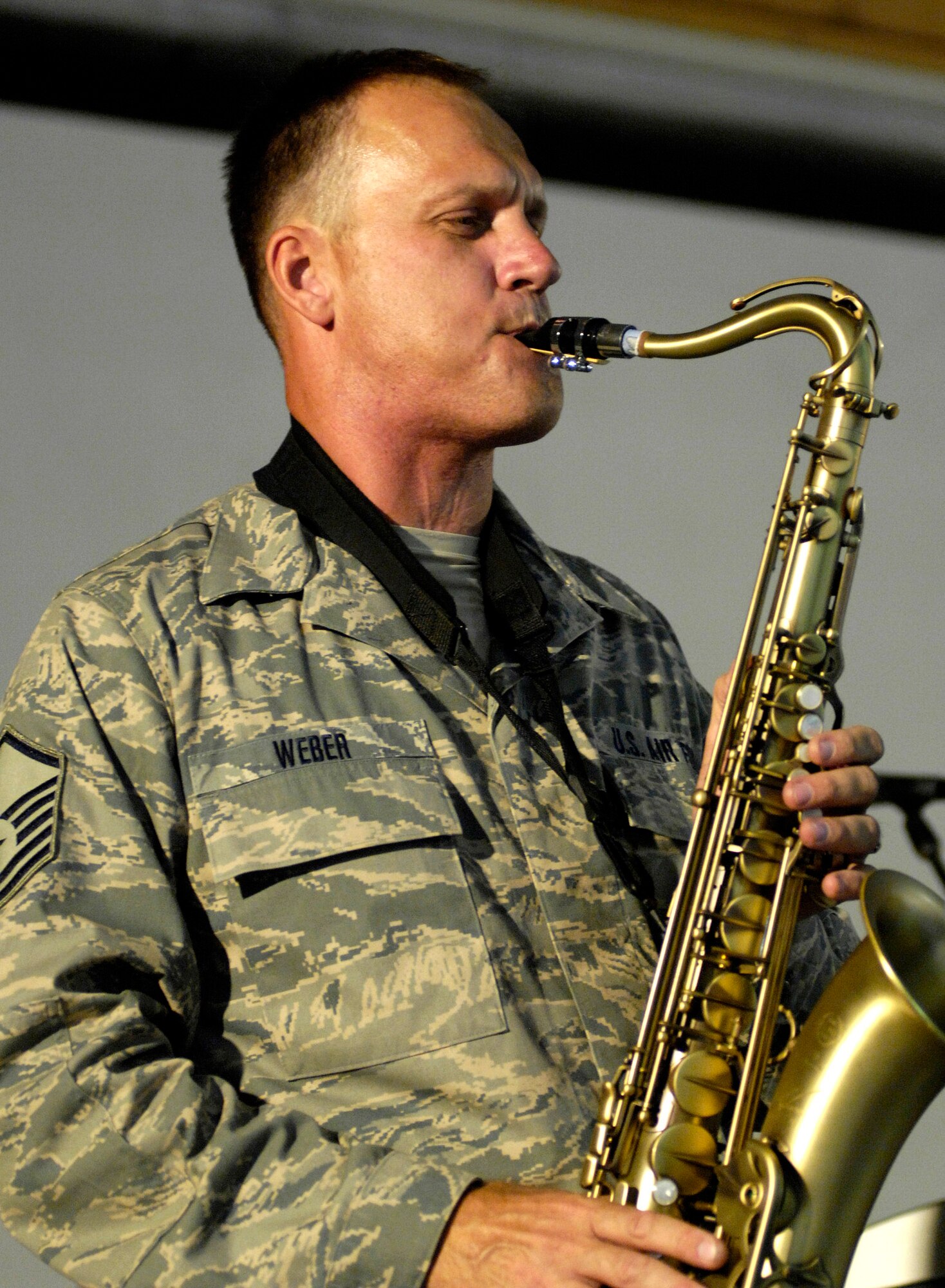 Master Sgt. Daniel Weber plays a solo during a show June 22 at Bagram Air Base, Afghanistan. The U.S. Air Forces Central Band "Falcon" band travels throughout the area of responsibility to positively promote troop morale and to reach out to host nation communities. Sergeant Weber is a U.S. Air Forces Band "Falcon" saxophonist. (U.S. Air Force photo/Master Sgt. Demetrius Lester)