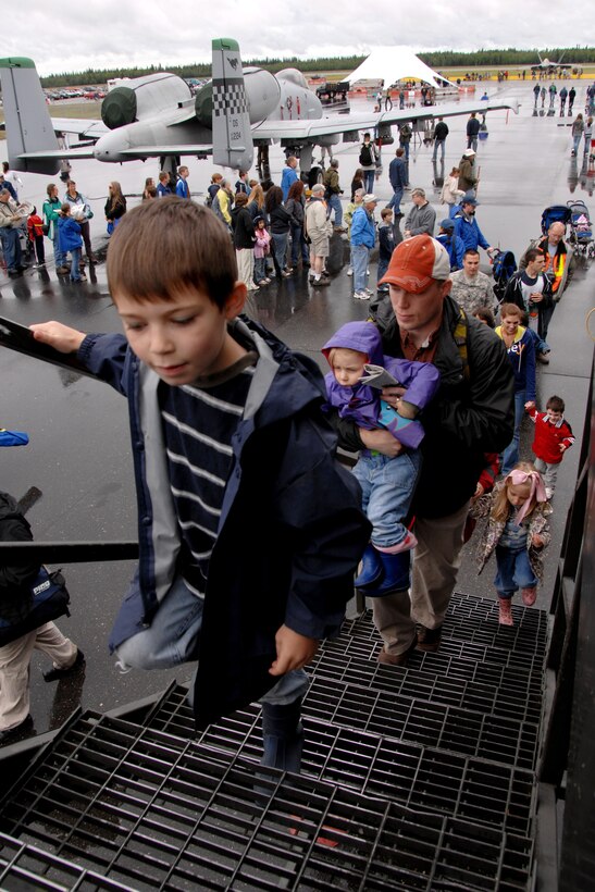 Ian Roberts boards a KC-135 Stratotanker during the June 24 airshow at Eielson Air Force Base, Alaska. The Eielson AFB airshow allowed the citizens of the surrounding towns to get an up close view and demonstration of the capabilities of the Air Force's aircraft. Ian is from North Pole, Alaska. (U.S Air Force photo/Tech Sgt. Eric T. Sheler) 