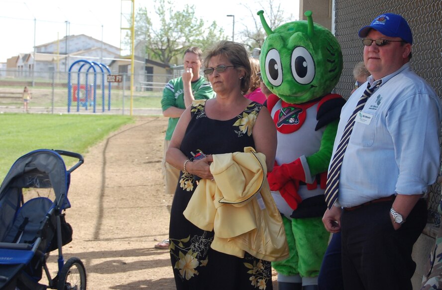 Dimmer Kjelsrud and Steve Grooms, First Liberty Credit Union representatives, and Orbit, the Great Falls Voyagers baseball team's mascot, look on at the Little League closing day ceremony, where certificates and pins were given to the Little Warriors who participated throughout the season. First Liberty was a contributor to the sucess of the season and sponsored free photo opportunities at the closing ceremony June 23. (U.S. Air Force photo/Airman 1st Class Emerald Ralston)