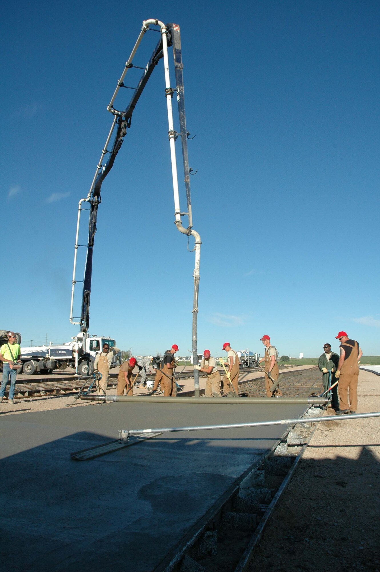 Members of the 819th RED HORSE Squadron pour concrete near the base heat plant Friday. (U.S. Air Force photo/ Airman 1st Class Dillon White)