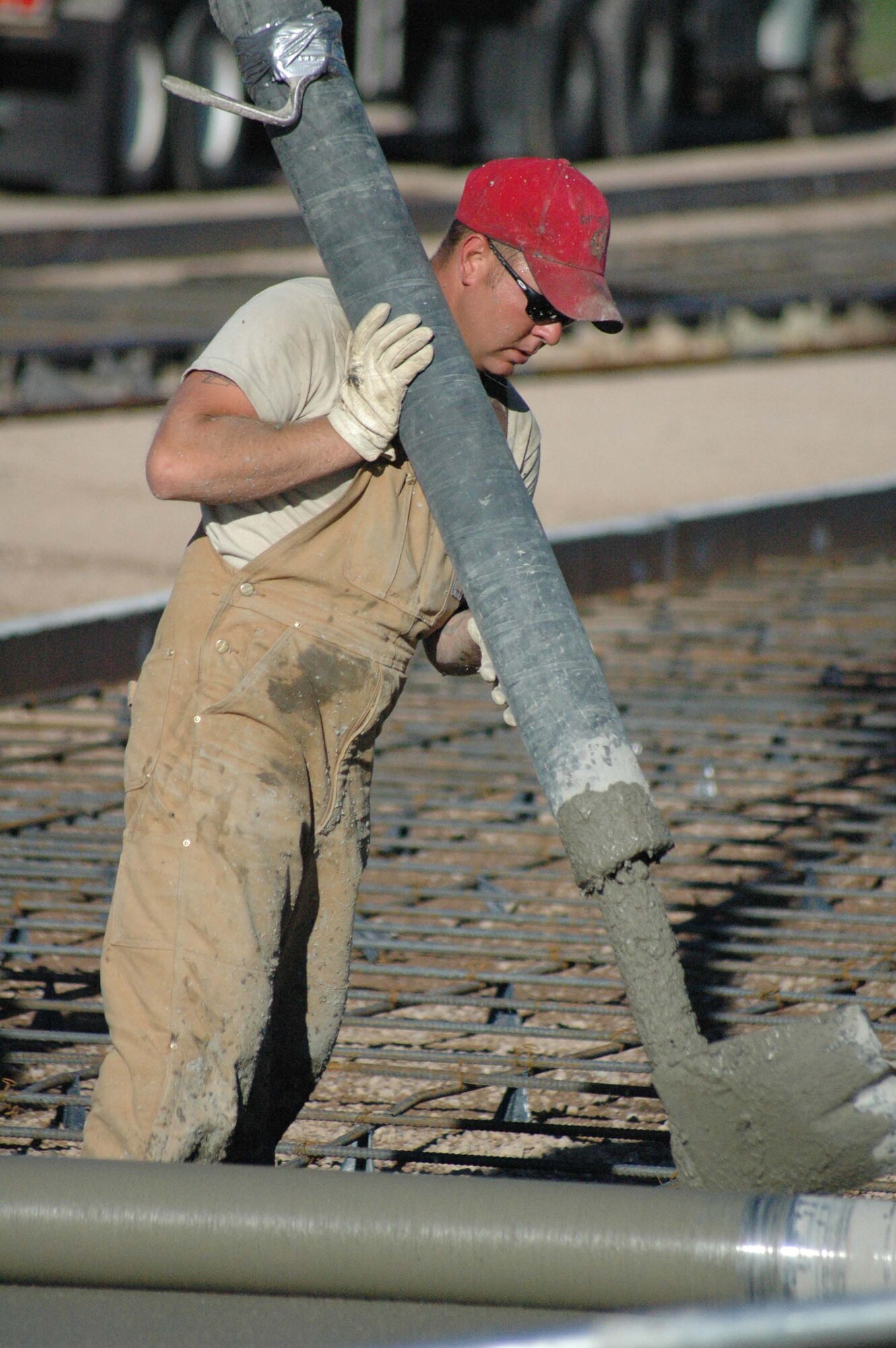 Senior Airman Bobby Merriman, 819th RED HORSE Squadron, controls a cement chute as Airmen construct a coal storage pad by the base heat plant Friday. (U.S. Air Force photo/ Airman 1st Class Dillon White)