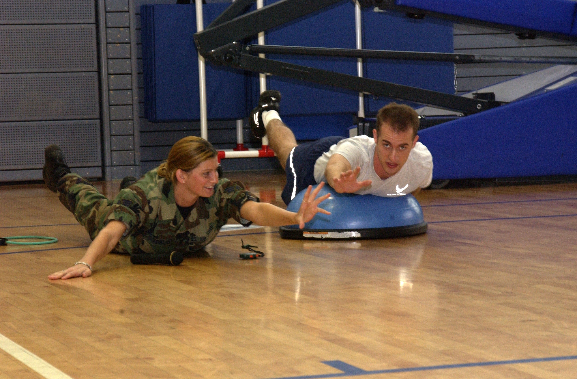 Senior Airman Katrina Scheibelhut of the 193rd Special Operations Wing, Middletown, Pa., demonstrates a superman exercise to Senior Airman Stephen Brest of the 1st Air and Space Communication Squadron during circuit training at Ramstein Air Base, Germany. Scheibelhut is one of many Airmen from the 193rd SOW who went to Ramstein for Air National Guard annual training during June. Courtesy photo