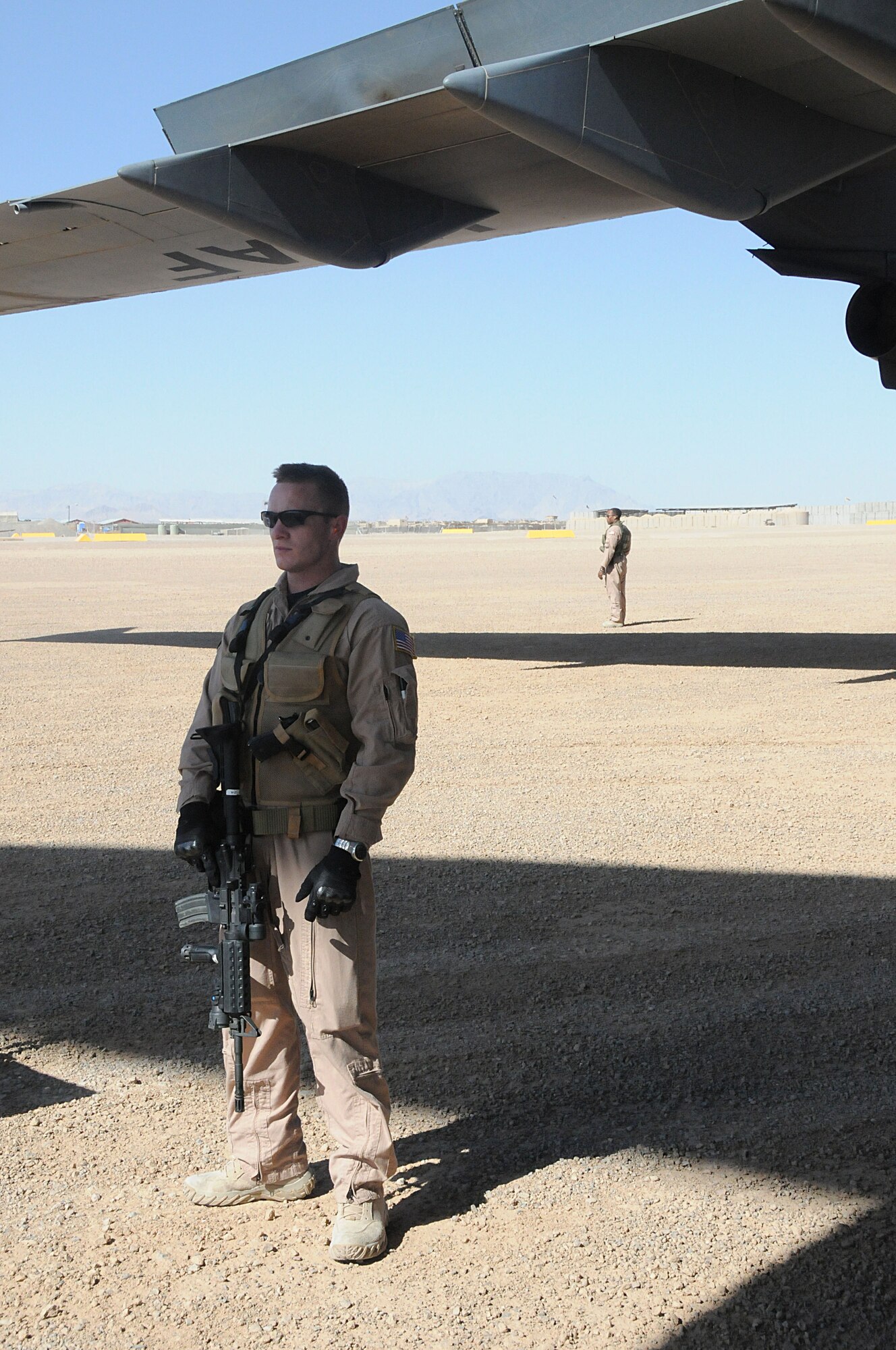 SOUTHWEST ASIA-Senior Airman Rimmond Fay, and Staff Sgt. Dennis Proctor (rear), PHOENIX RAVENS Security Forces members attached to the 816th Expeditionary Airlift Squadron, provide security at an austere location in Afghanistan, June 19. RAVENS are specially trained to help detect, deter and counter threats to Air Mobility Command aircraft by performing close-in aircraft security. (U.S. Air Force photo/ Senior Airman Tong Duong)