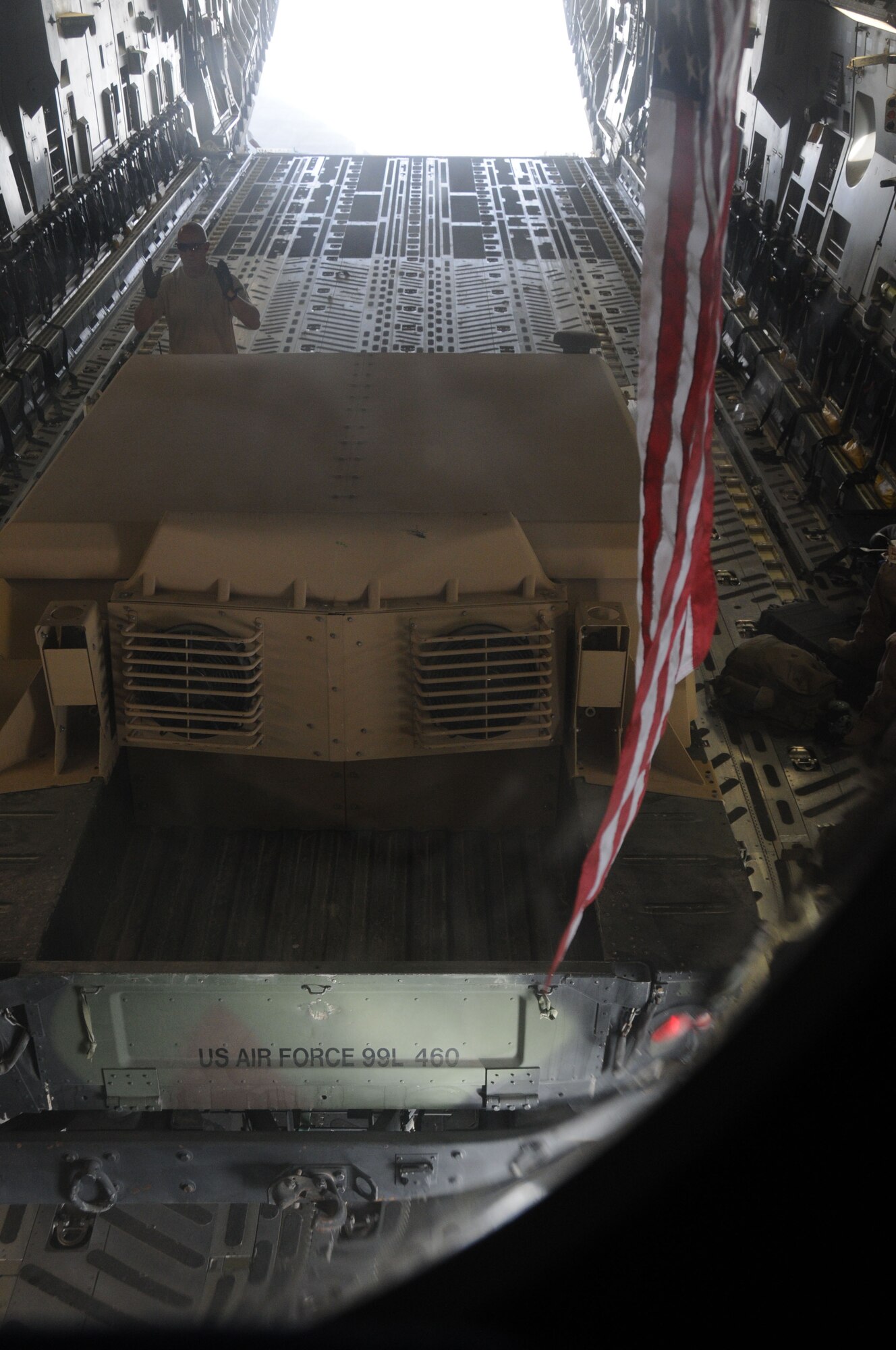 SOUTHWEST ASIA-Senior Airman Russ Ludeman, 816th Expeditionary Airlift Squadron loadmaster spots a  high mobility multipurpose wheeled vehicle backing into a C-17 at Kandahar Air Base, Afghanistan June 19. (U.S. Air Force photo/ Senior Airman Tong Duong)