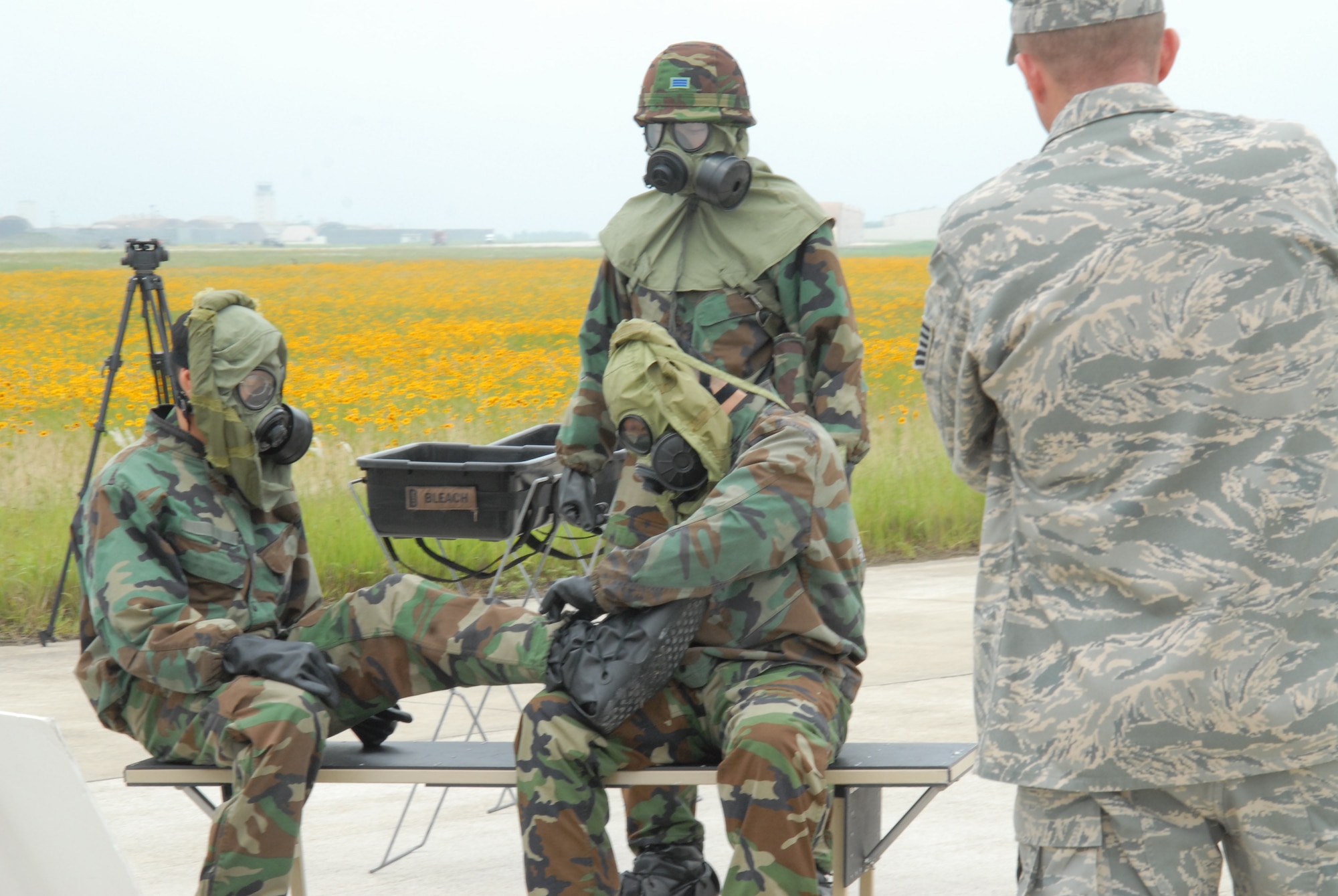 KUNSAN AIR BASE, Republic of Korea — Tech. Sgt. Frank Roman, NCO in charge of readiness and training from the 8th Civil Engineer squadron observes Republic of Korea Army soldiers while they remove their chemical warfare gear here 24 June. (U.S. Air Force Photo/Staff Sgt Araceli Alarcon)
