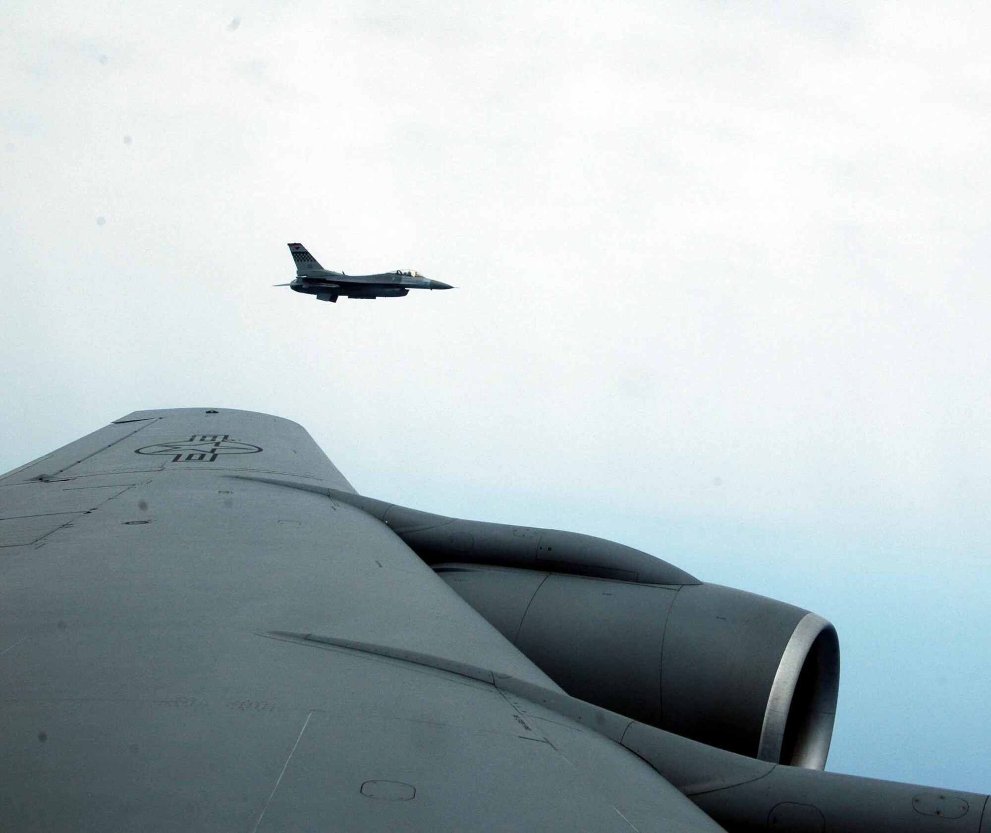 OSAN AIR BASE, Republic of Korea-- An F-16 Fighting Falcon from the 36th Fighter Squadron flies by after receiving fuel from a KC-135 during a routine mission over the Korean Peninsula June 25. The KC-135 was flown by members of the 336th Air Refueling Squadron, March Air Reserve Base, Calif. (U.S. Air Force photo/Staff Sgt. Candy Knight)