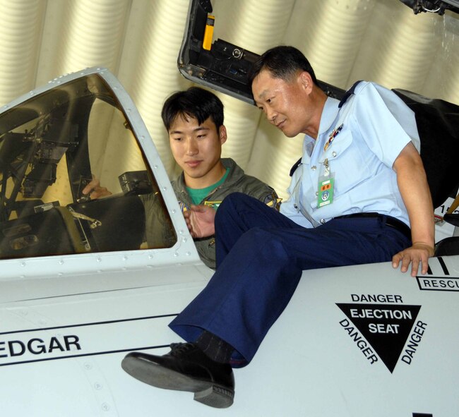 OSAN AIR BASE, Republic of Korea -- 1st Lt. Al Chang, 25th Fighter Squadron A-10 pilot, shows Lt. Col. Lee Chul Su, Korean Air University instructor, the cockpit of an A-10 during the colonel's visit June 20. (U.S. Air Force photo/Senior Airman Christopher Boitz)
