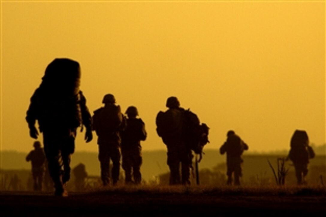 U.S. Army paratroopers assigned to the 82nd Airborne Division walk toward their rally point after jumping from a C-17 Globemaster III aircraft during a joint exercise on Fort Bragg, N.C., June 18, 2008. 