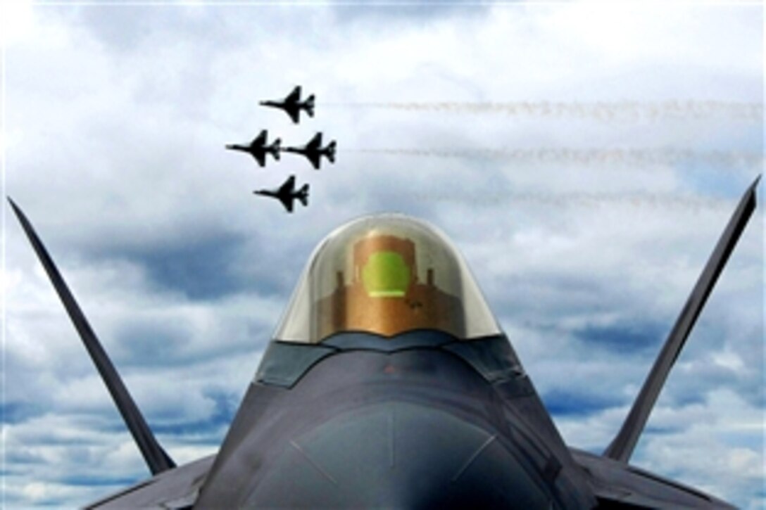 Four Air Force Thunderbird F-16 Fighting Falcons fly in formation behind an F-22 Raptor for more than 6,000 spectators during the, June 24, 2008, airshow at Eielson Air Force Base, Alaska. The "Soaring into Solstice" airshow provided an opportunity for the local community to visit and get an up close view and demonstration of the capabilities of the Air Force's aircraft.