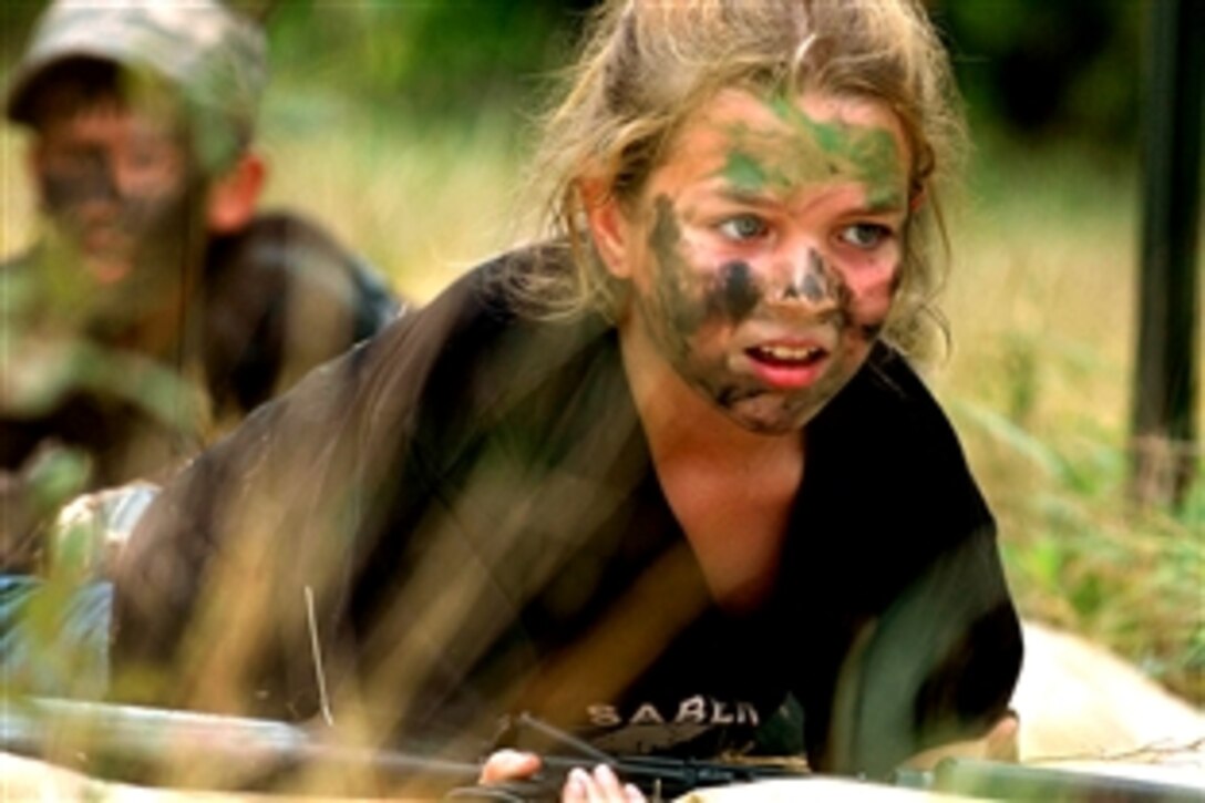 A girl low crawls while maintaining control of her “weapon” as part of the 1st Cavalry Division’s 6th Squadron, 9th Cavalry Regiment Saber Spur Ride to allow the children of soldiers to train as soldiers for a day on Fort Hood, Texas, June 20, 2008. The child is performing the last leg of a rigorous obstacle course that included a rope climbing exercise and a zip line. 

