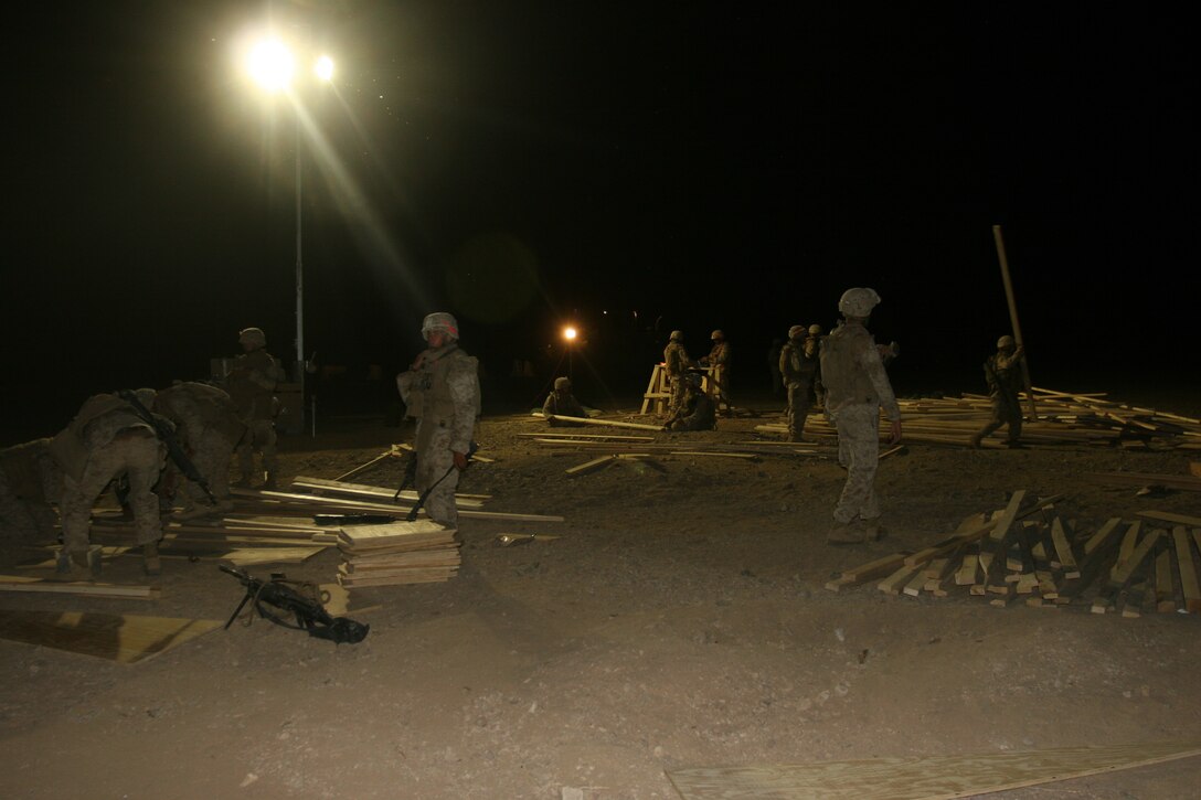 Marines with Alpha Company, 9th Engineer Support Battalion, work through the night using generator-powered lights so that they can see while building a compound for their battalion June 26, 2008, during Mojave Viper, a month-long pre-deployment training evolution aboard the Combat Center.