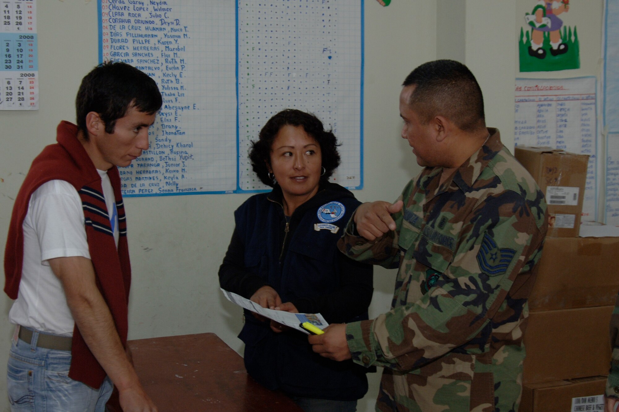 U.S. Air Force Tech. Sgt. Jose Urquiza , a pharmacy technician assigned to Task Force New Horizons, and a Peruvian health official assist a Peruvian man being treated by U.S. servicemembers, June 26,  with prescribed medicine during New Horizons - Peru 2008, a U.S. and Peruvian effort focused on Providing relief to underprivileged Peruvians. (U.S. Air Force photo / by Tech. Sgt. Kerry Jackson)