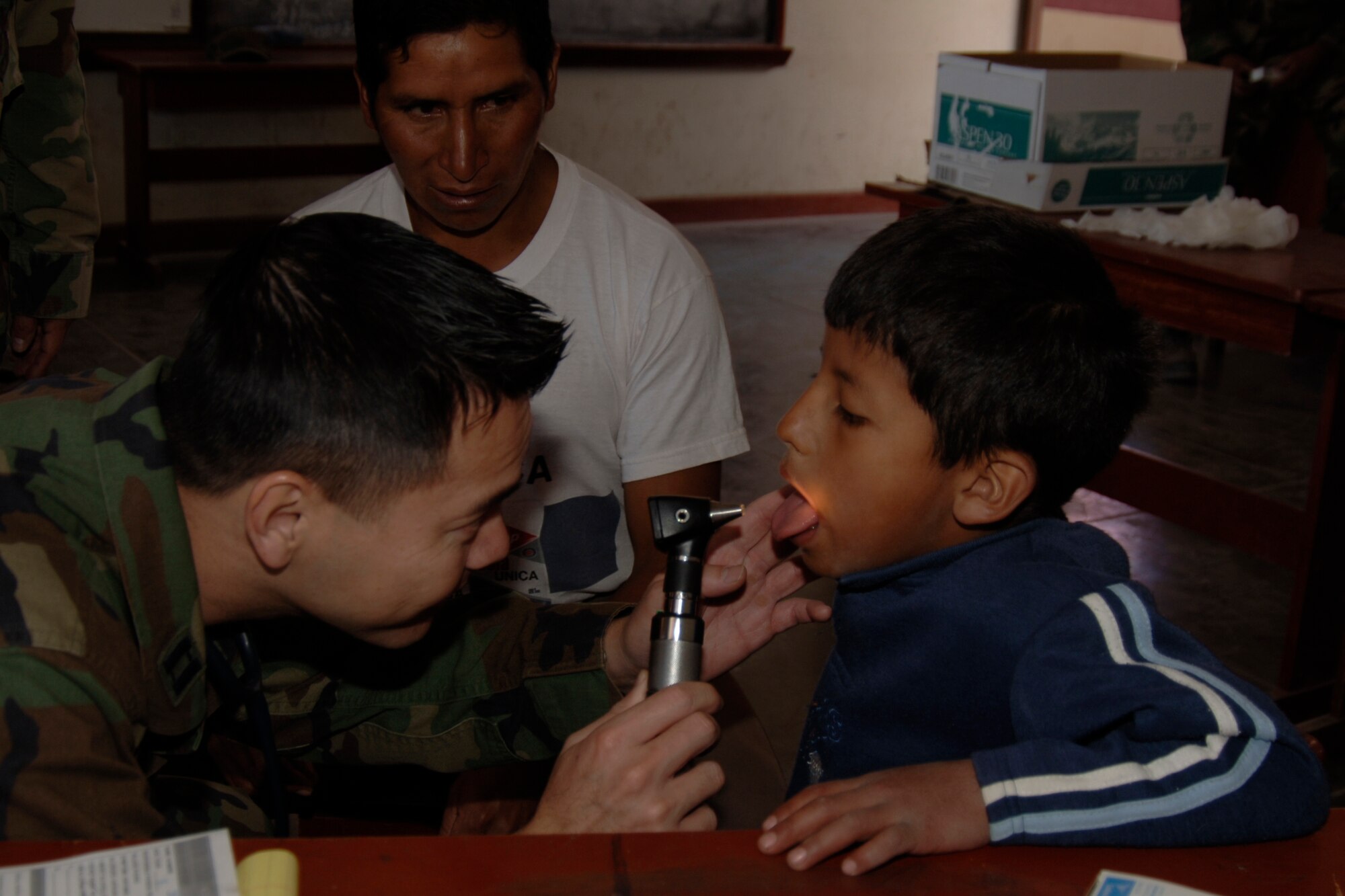 U.S. Air Force Capt. Truong Quach, a doctor assigned to Task Force New Horizons, treats a Peruvian boy, June 26, during a medical mission supporting New Horizons Peru - 2008, a U.S. and Peruvian humanitarian effort to provide relief to underprivileged Peruvians. (U.S. Air Force photo / by Tech. Sgt. Kerry Jackson)