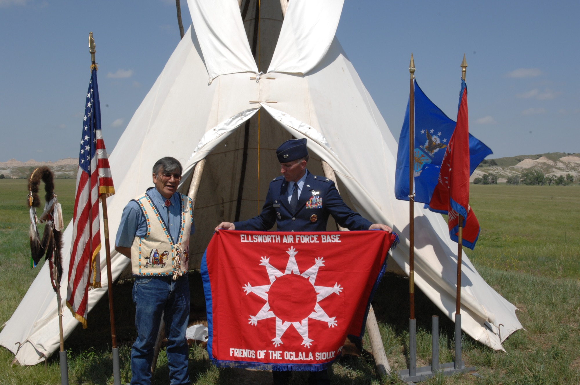Col. Scott Vander Hamm, 28th Bomb Wing commander, is presented a flag by Yellow Bird-Steele Oglala Sioux Tribe president, at the Tribal Consultation Plan signing held at the White River Visitor Center on the Pine Ridge Reservation, S.D., June 26, 2008. The Air Force is looking forward to working together with the OST as this project moves forward to steady clean up the Retained Area, an ensure sustained teamwork and open communication throughout the life of the project. (U.S. Air Force photo/ Airman 1st Class Adam Grant)