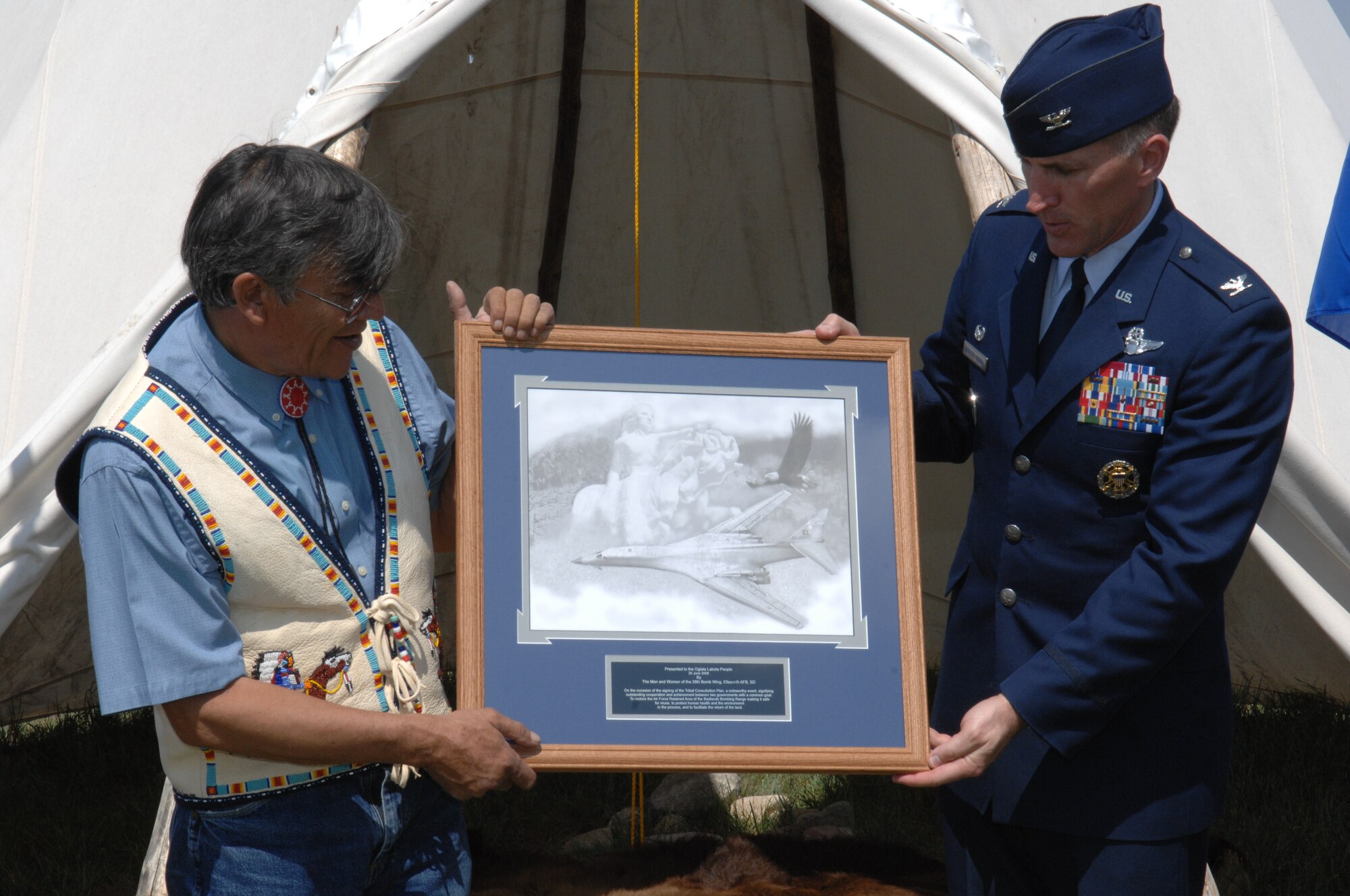 Oglala Sioux Tribe president, a plaque at the Tribal Consultation Plan signing held at the White River Visitor Center on the Pine Ridge Reservation, S.D., June 26, 2008. The Air Force is committed to being a good steward of the environment; with the establishment of this plan, the Air Force is stating its commitment to protect both human health and the environment through the effort to clean-up the Air Force Retained Area.  (U.S. Air Force photo/ Airman 1st Class Adam Grant)




