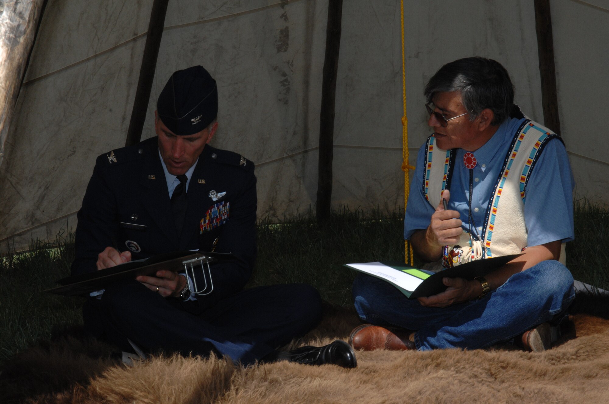 Col. Scott Vander Hamm, 28th Bomb Wing commander, and Yellow Bird-Steele, Oglala Sioux Tribe president, sign a Tribal Consultation Plan at the White River Visitor Center on the Pine Ridge Reservation, S.D., June 26, 2008. In signing this document, the Air Force is making a commitment to establishing open lines of communication between both the Air Force and the Oglala Sioux Tribe with a common goal in mind. (U.S. Air Force photo/ Airman 1st Class Adam Grant)

