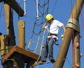 MINOT AIR FORCE BASE, N.D. -- Alex Ayres, son of Col. Christopher Ayres, 91st Space Wing commander, negotiates a tough section of the confidence tower at Y Camp. Youth from Minot Air Force Base attended a youth camp hosted by the 5th Force Support Squadron and the Minot AFB Youth Center June 20 through June 22 at the Y Camp near Garrison, N.D. (U.S.Air Force photo by Airman 1st Class Benjamin Stratton)
