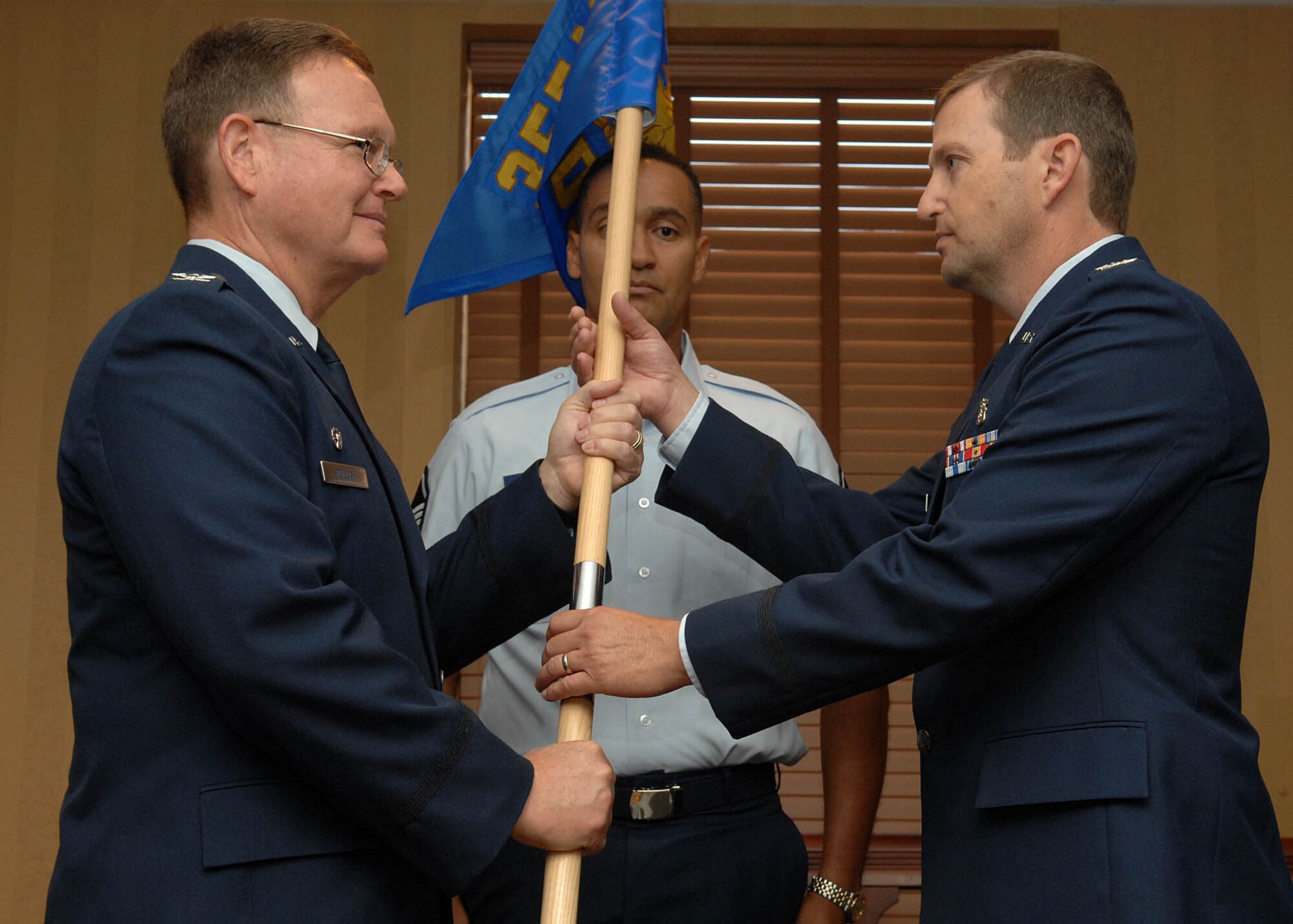 Col. Lynn Harris (right) receives the 355th Dental Squadron guidon from the 355th Medical Group Commander Col. William A. Pollan during a change-of-command ceremony here June 27. Colonel Harris assumed command of the 355th DS after serving as the Deputy Commander for the 341st Medical Group at Malmstrom Air Force Base, Montana. (U.S. Air Force Base Photo By: Senior Airman Jacqueline Hawkins)