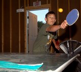 MINOT AIR FORCE BASE, N.D. -- Keagan Wyatt, son of 1st Lt. Aubrie Jones, 5th Force Support Squadron, enjoys a game of ping-pong in the male cabin at Y Camp. Youth from Minot Air Force Base attended a youth camp hosted by the 5th FSS and the Minot AFB Youth Center June 20 through June 22 at the Y Camp near Garrison, N.D. (U.S. Air Force photo by Airman 1st Class Benjamin Stratton)
